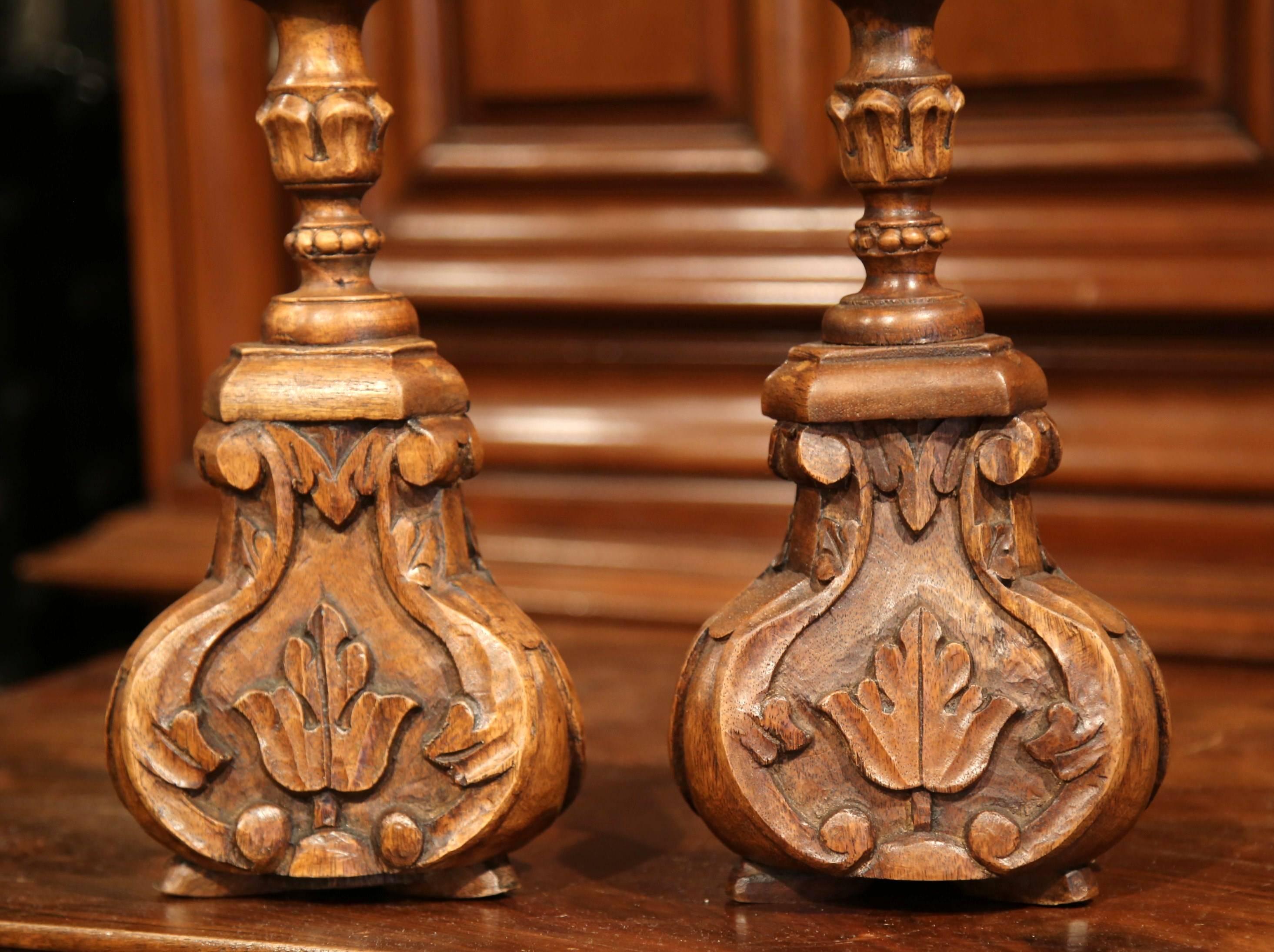 Decorate a table or mantel with this pair of beautifully hand-carved, antique fruitwood candlesticks. Crafted in France circa 1890, the altar sticks have Classic floral carvings and other decorative motifs that will fit into any style of home. Each