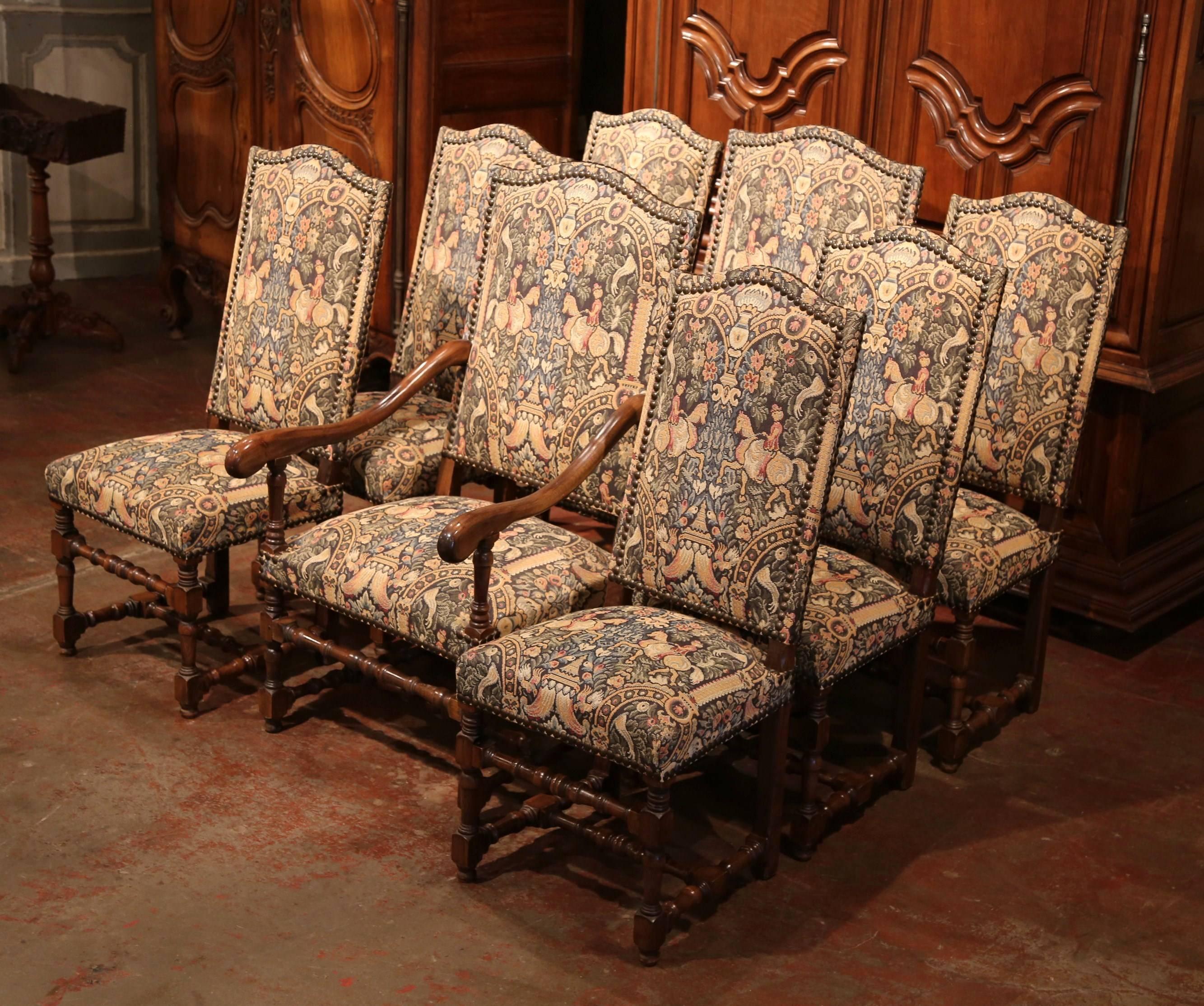 This fine set of dining room chairs and armchairs was crafted in France, circa 1980. All eight chairs in the set feature nicely turned legs with stretchers, a high back and wide seat for comfort. Each piece is upholstered on the back and seat