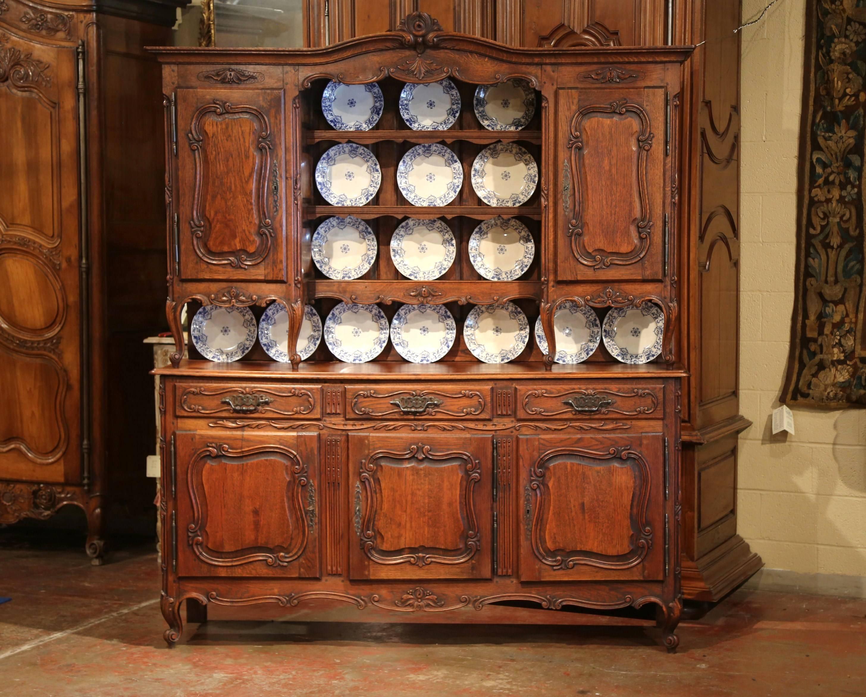 Display your dishes in this elegant antique two-piece vaisselier from Northern France. Crafted, circa 1920, the top cabinet sits on four cabriole legs, and features a three-shelf plate display with safety groove, and is flanked by a door on both