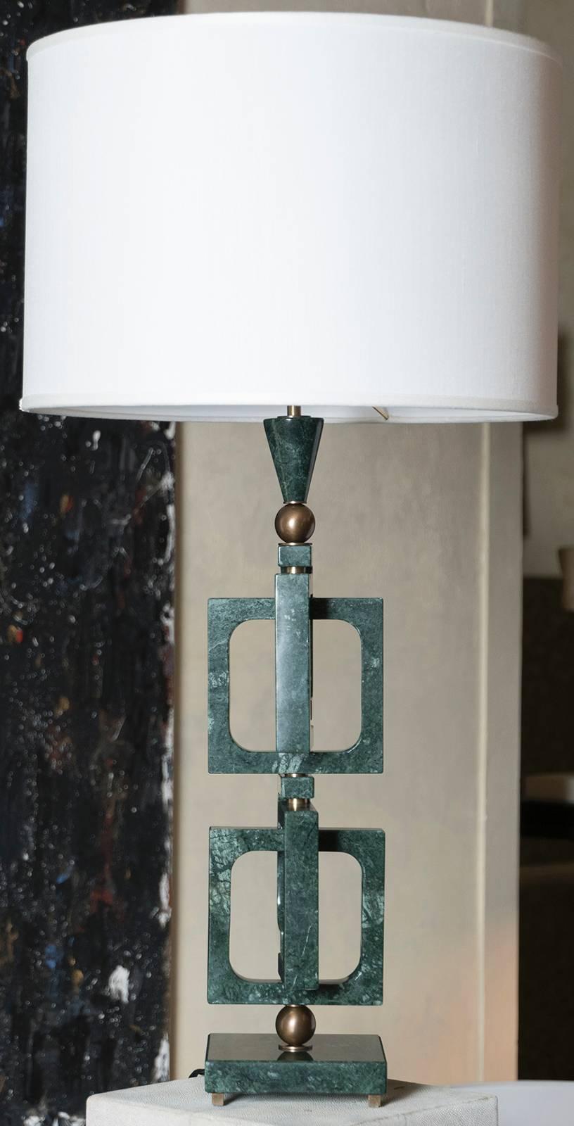 Sculptural lamp realized in Verde Guatemala marble with bronze details, also available in Nero Maquinia marble and Travertine Stone, lampshade cm 45x H.30, total high lampshade included cm 89.