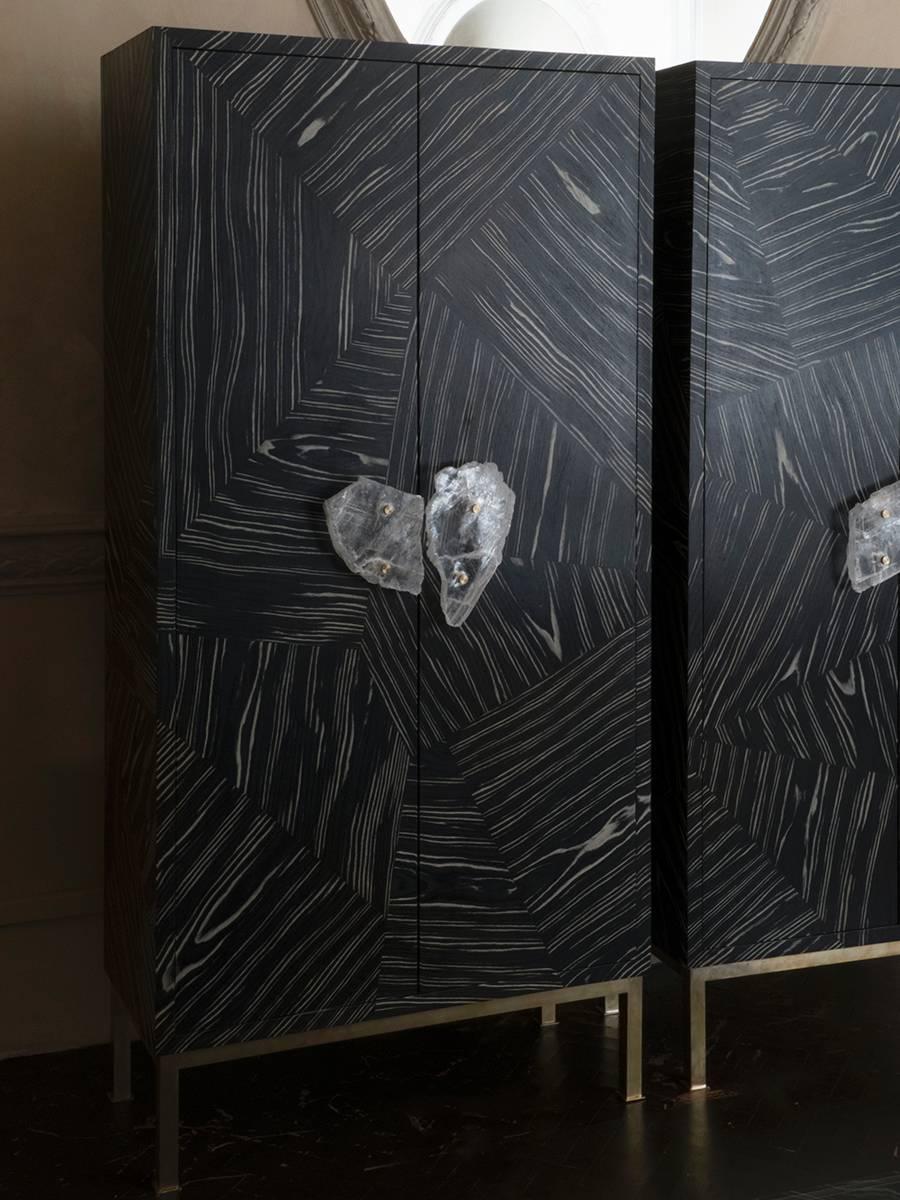 1980s Italian cabinets newly covered in marquetry black and ivory Ayous veneer, natural brass customized base and gypsum crystal handles.