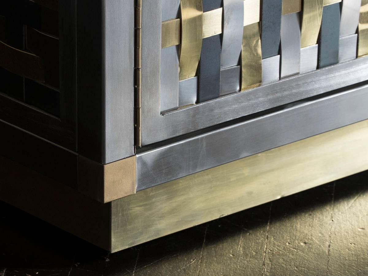 Brushed steel, raw iron and natural brass structure and hand weaving work all-over, natural brass details, tempered smoked grey glass shelve.