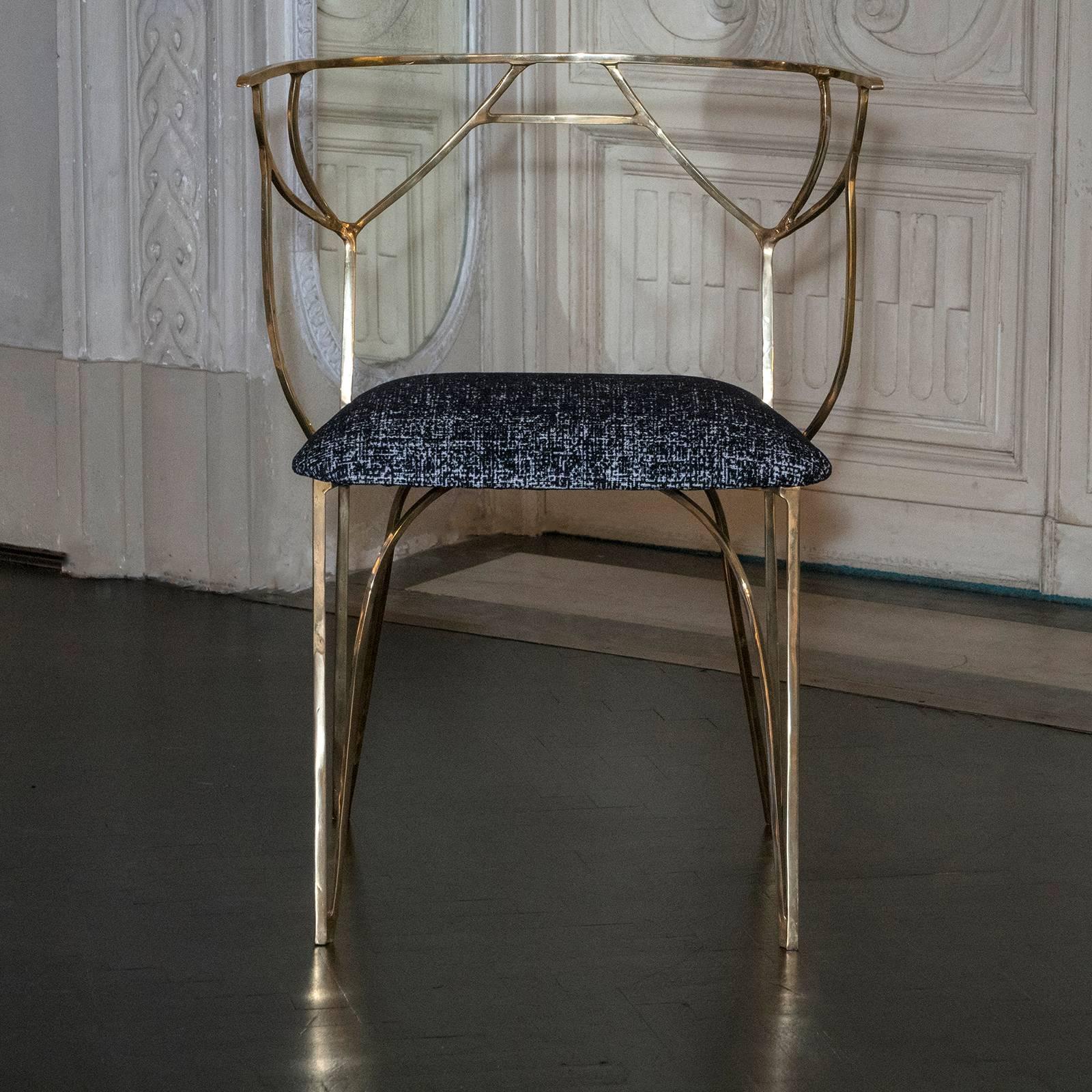 Sculptural dining chairs realized in gilded bronze, black and white velvet seat cushion.