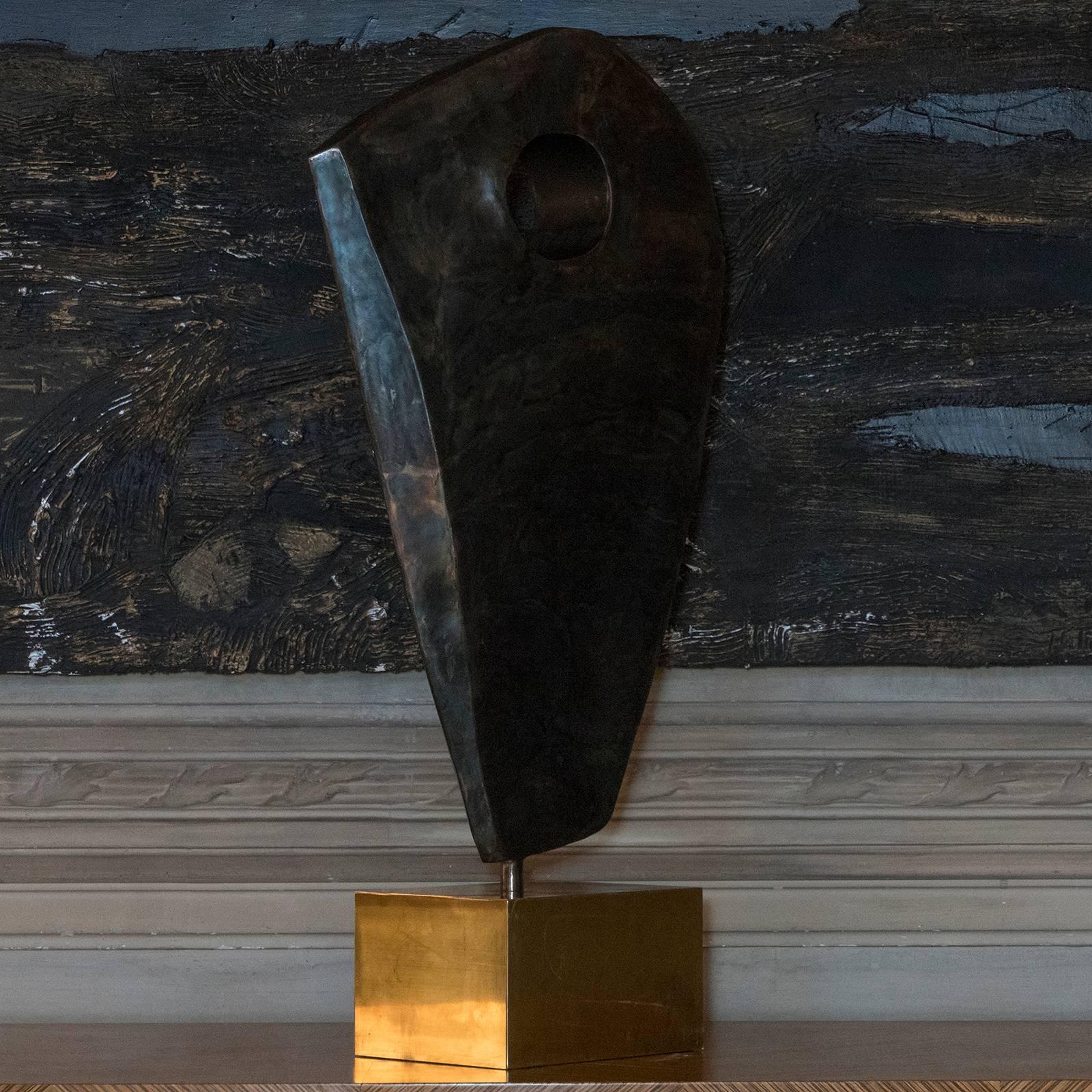 Contemporary abstract burnished steel sculpture, natural brass base.