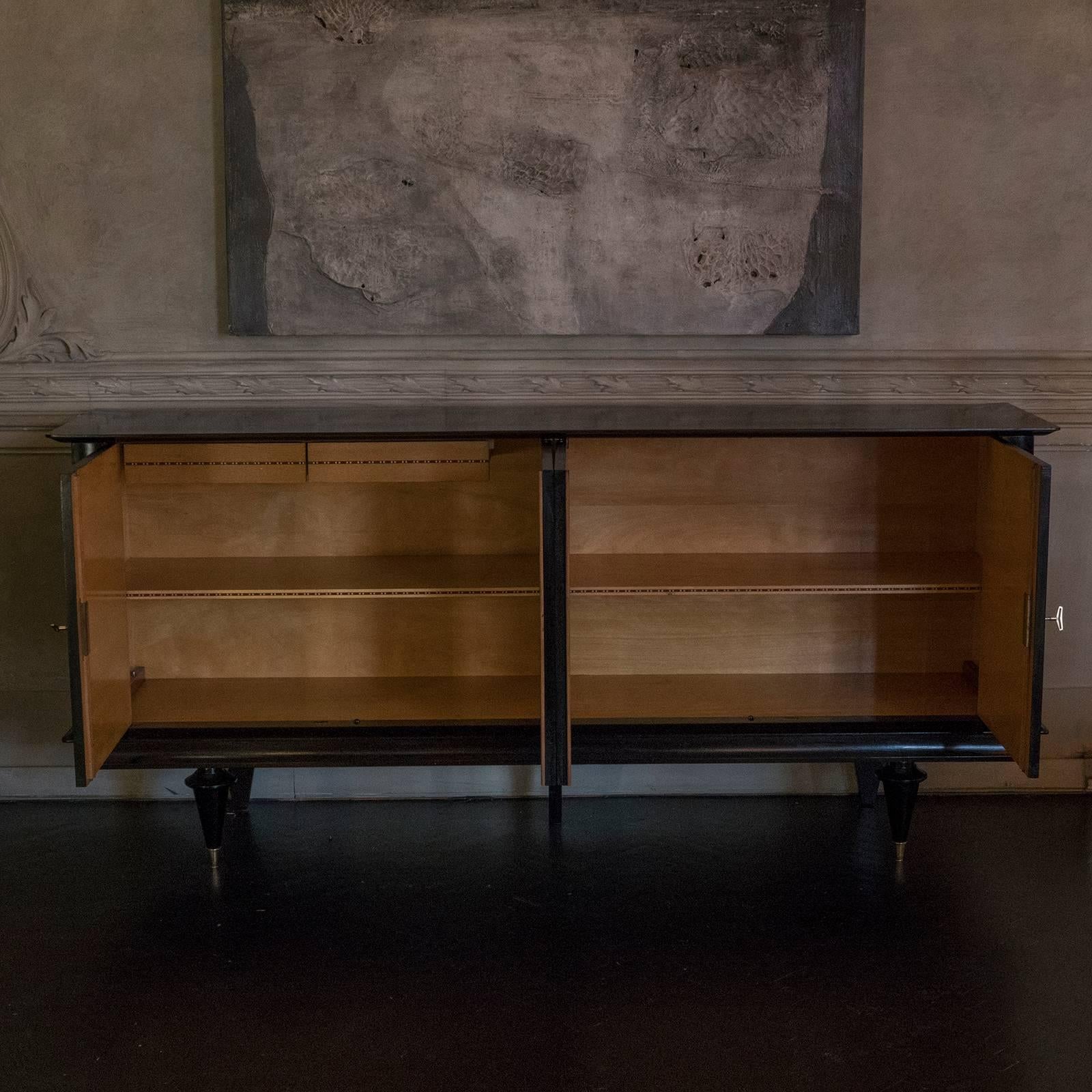 Ebonized cherrywood sideboard, interior with one central shelve and two drawers on one side, brass original details.