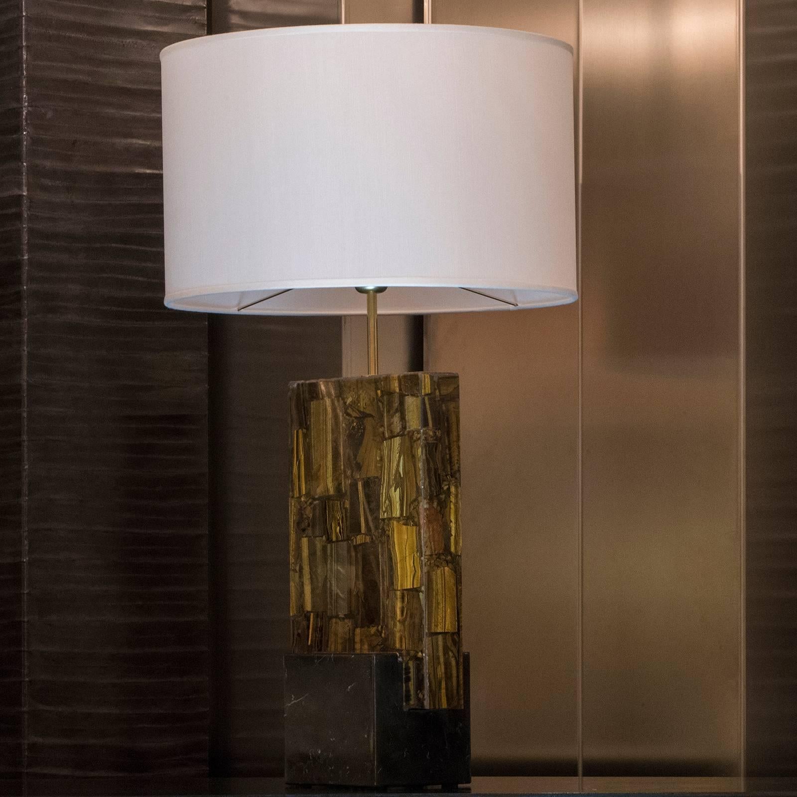 Sculptural table lamp in tiger eyes with black Marquinia marble base, white silk shantung lampshade measures: cm 50xH30, total high cm89, available the pair.