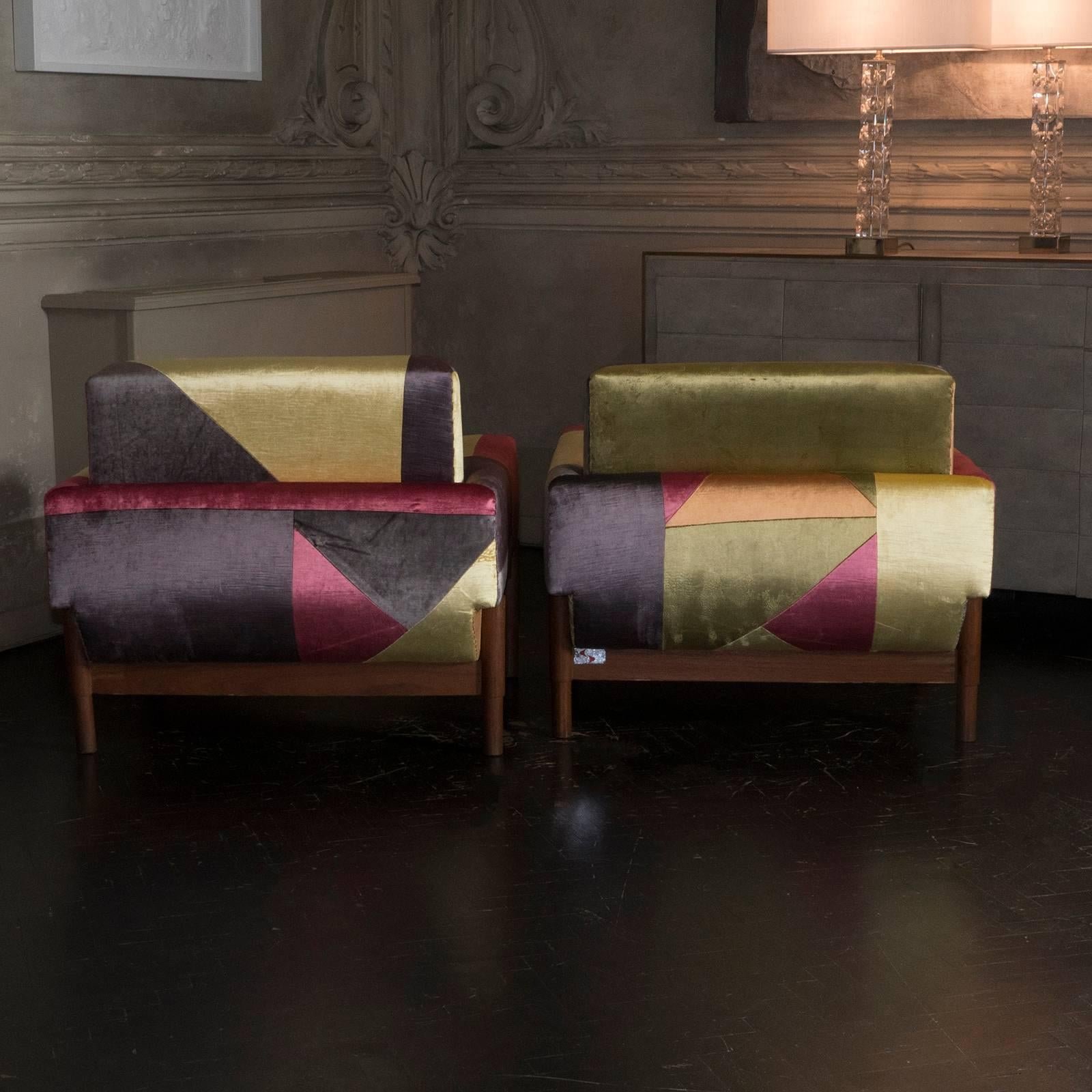 Pair of rosewood armchairs re-upholstered in patchwork multicolor velvet,
Excellent condition with beautiful vintage patina, some lacquered surface missed on the under base of the seat.
 