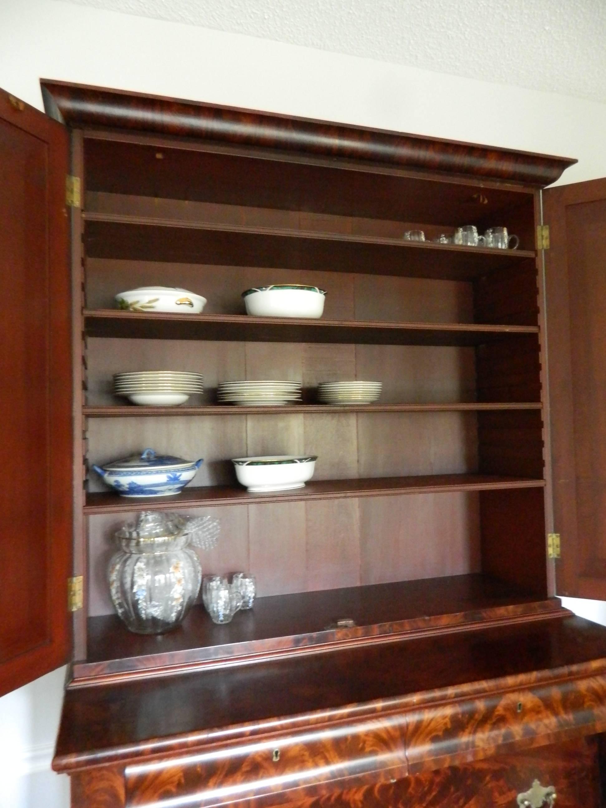 American Empire Style Crotch Mahogany Secretary and Bookcase, Late 18th Century. Five shelves on top part and two bottom drawers.
