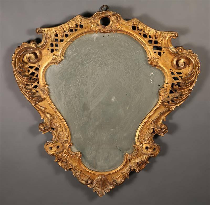 French Rococo style giltwood cartouche form mirror, late 19th century.
     