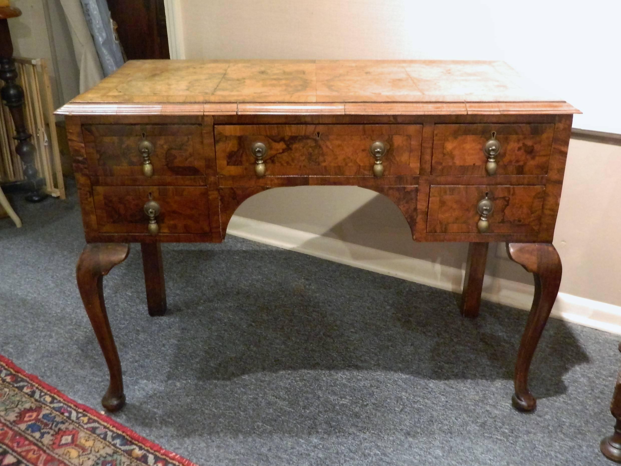 William and Mary burl walnut style desk with five drawers, 19th century.
      