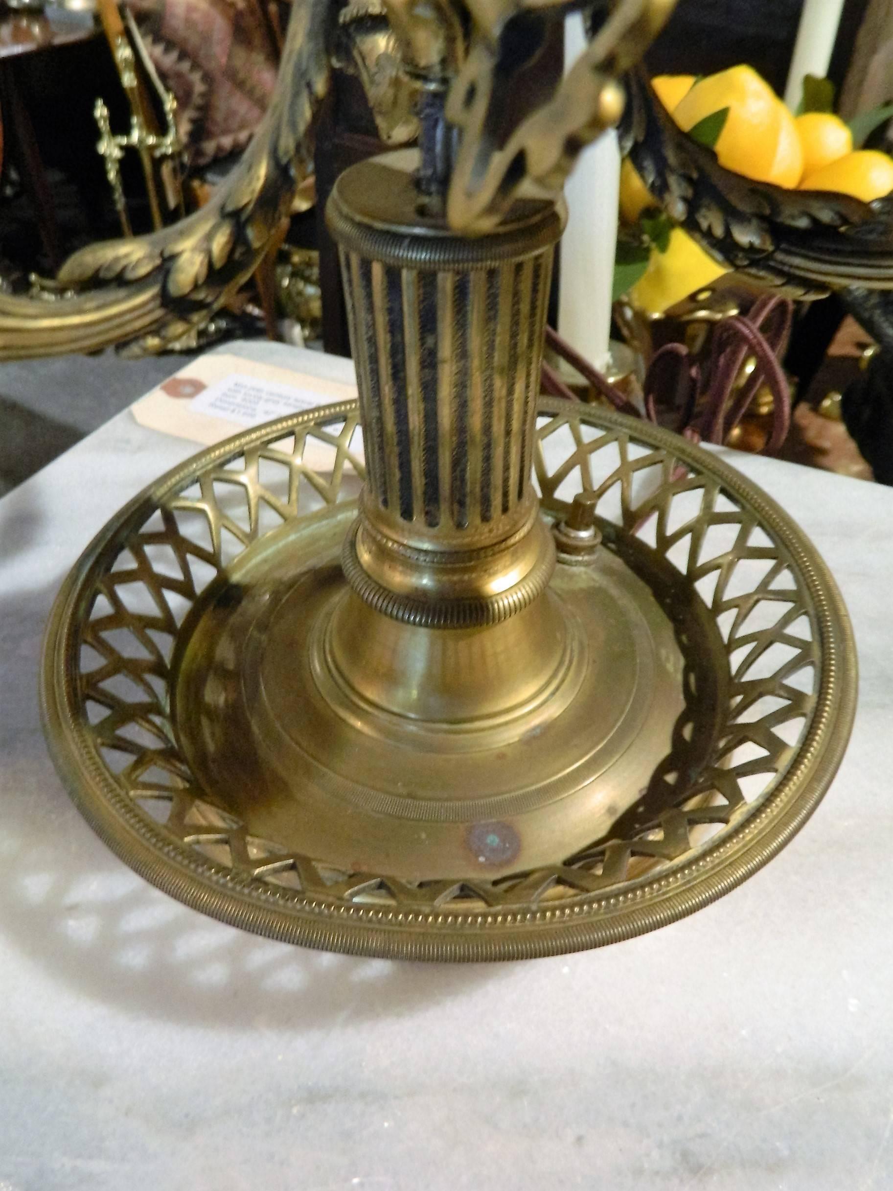 Late 19th-early 20th century brass bouillotte lamp with a reticulated base.
 
