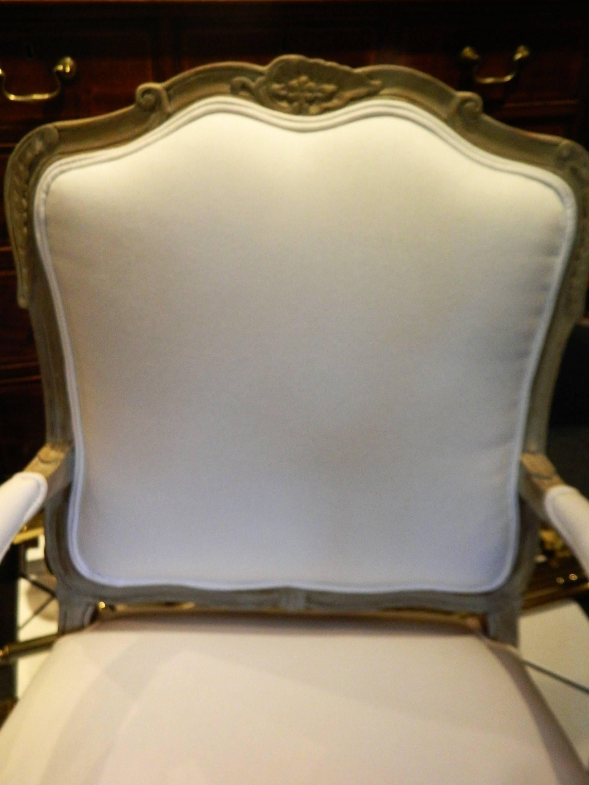 Louis XVI style upholstered open armchair, early 20th century. The upholstered back flanked by padded open arms centering an over upholstered seat, raised on cabriole legs.
 