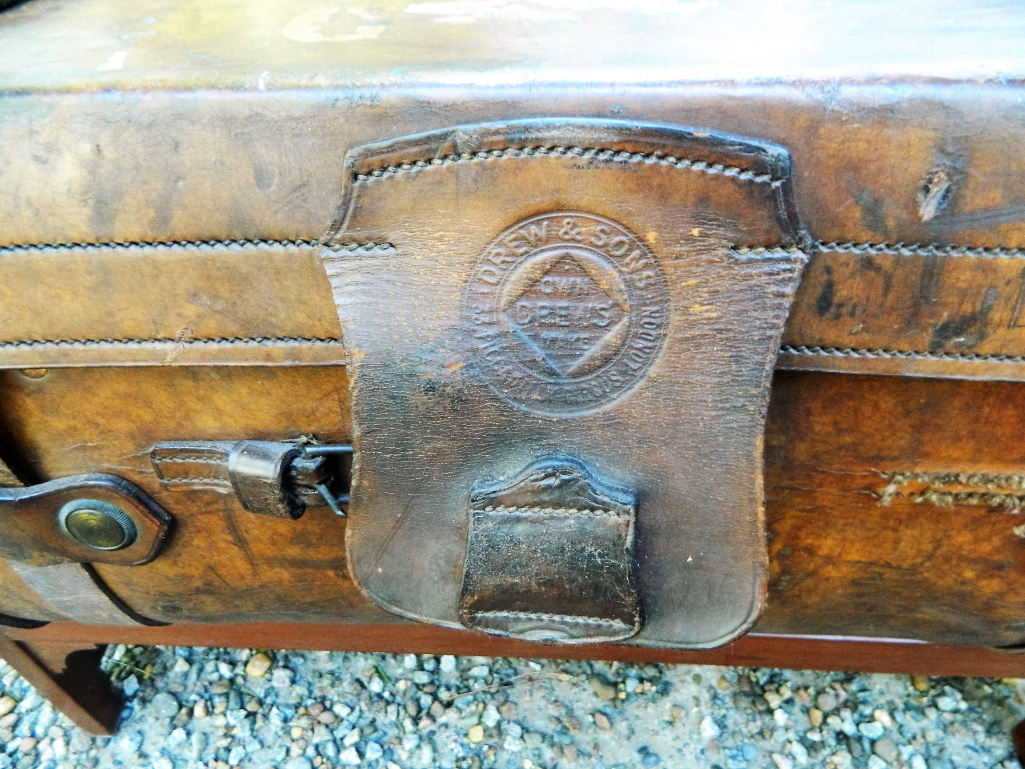 English leather suitcase adapted as a coffee table on a later stand, 19th century.
 