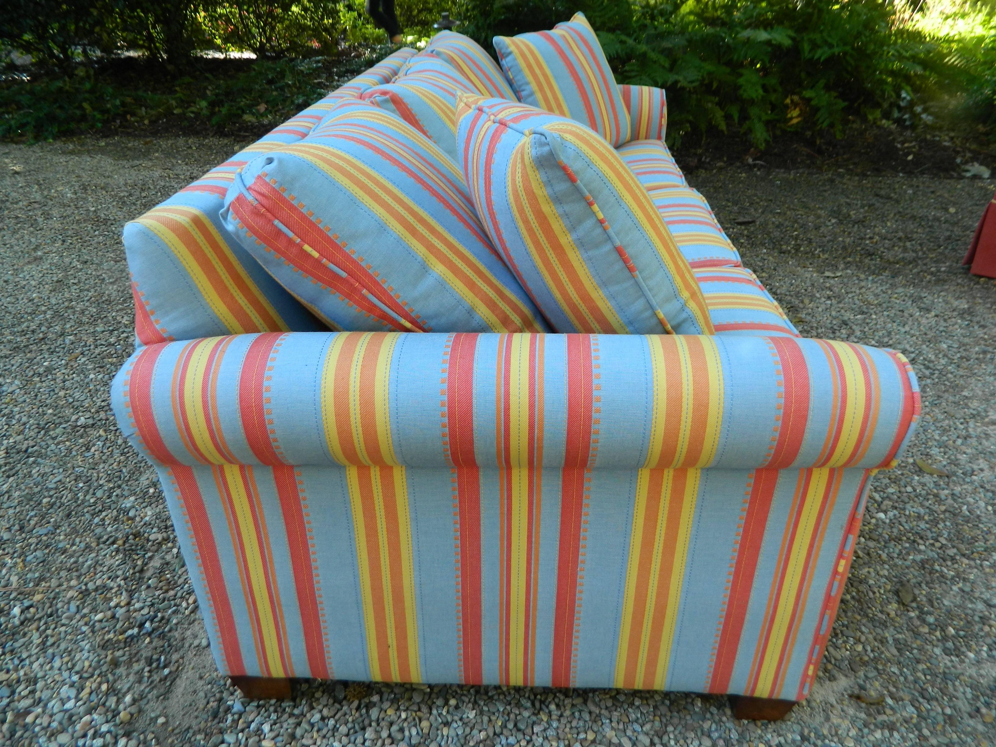 Upholstered sofa bed in a multi-color stripe fabric, 20th century.