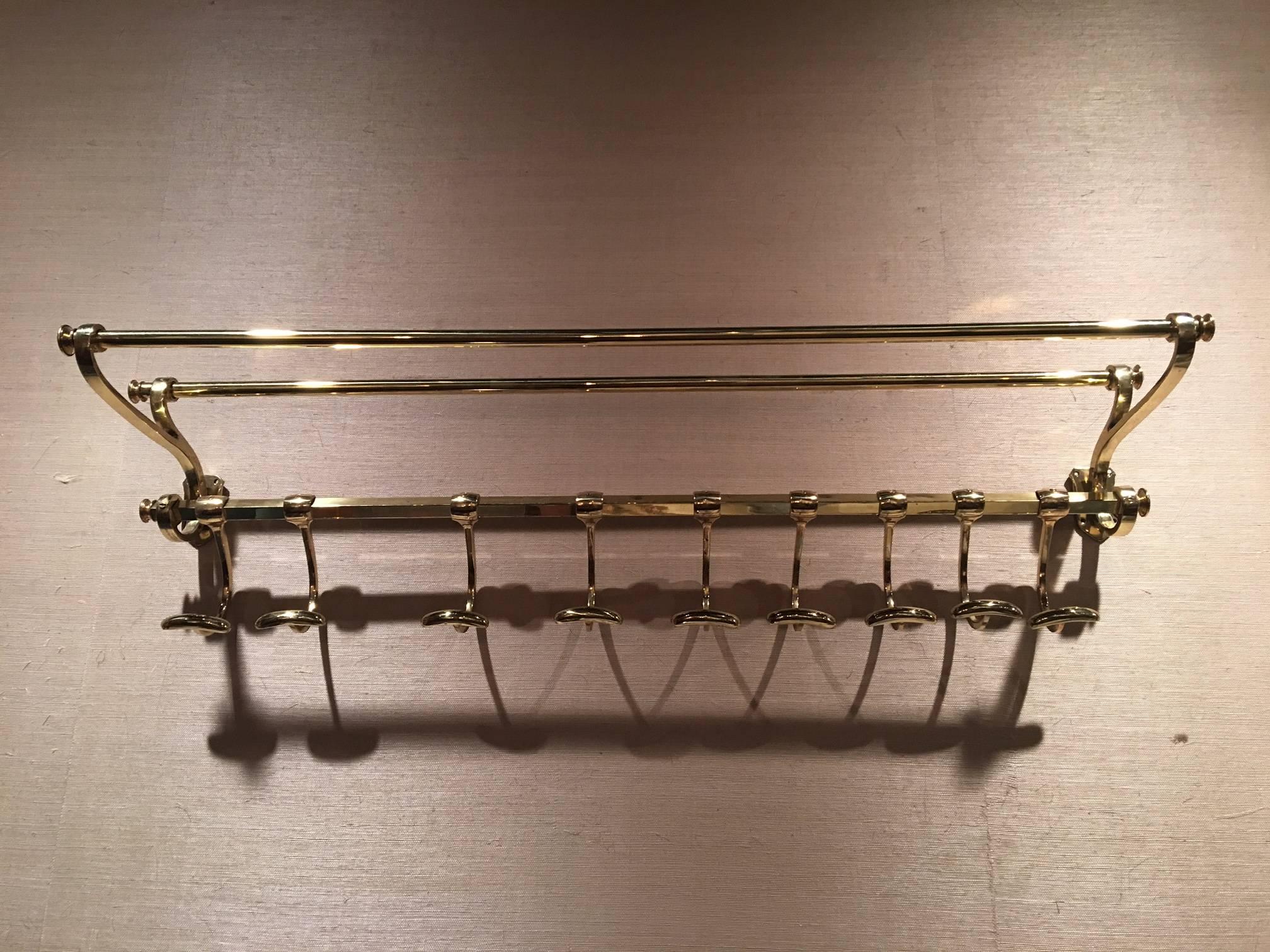 French solid brass coat rack and wall shelf, 19th century.
 