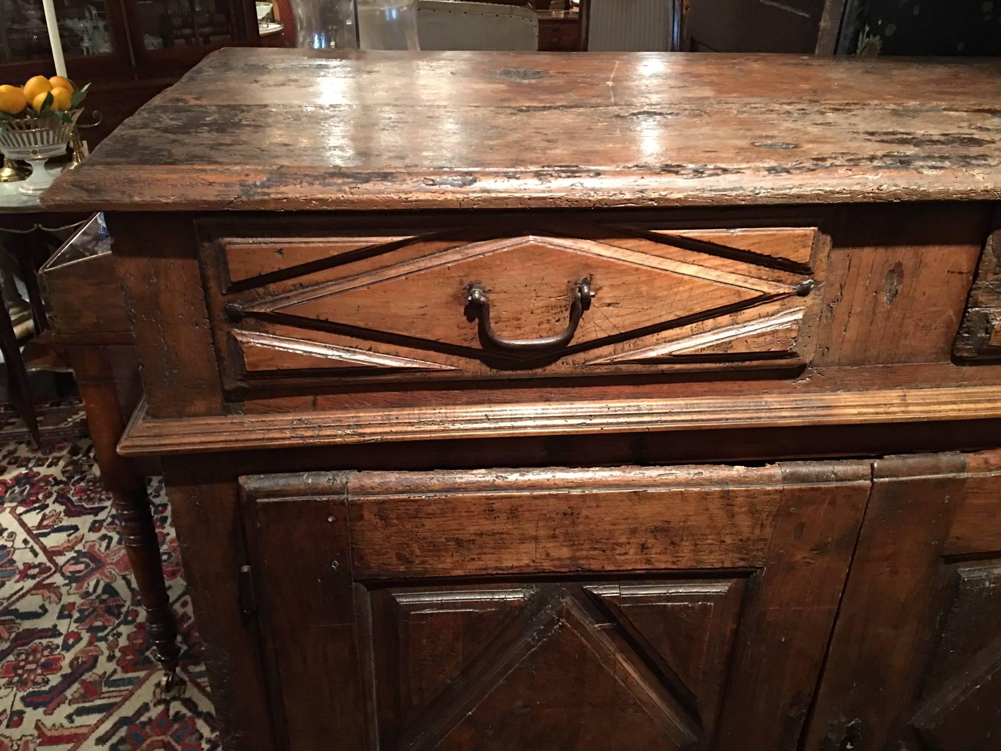 French walnut distressed buffet with two drawers and two doors opening to a shelf, 18th century.