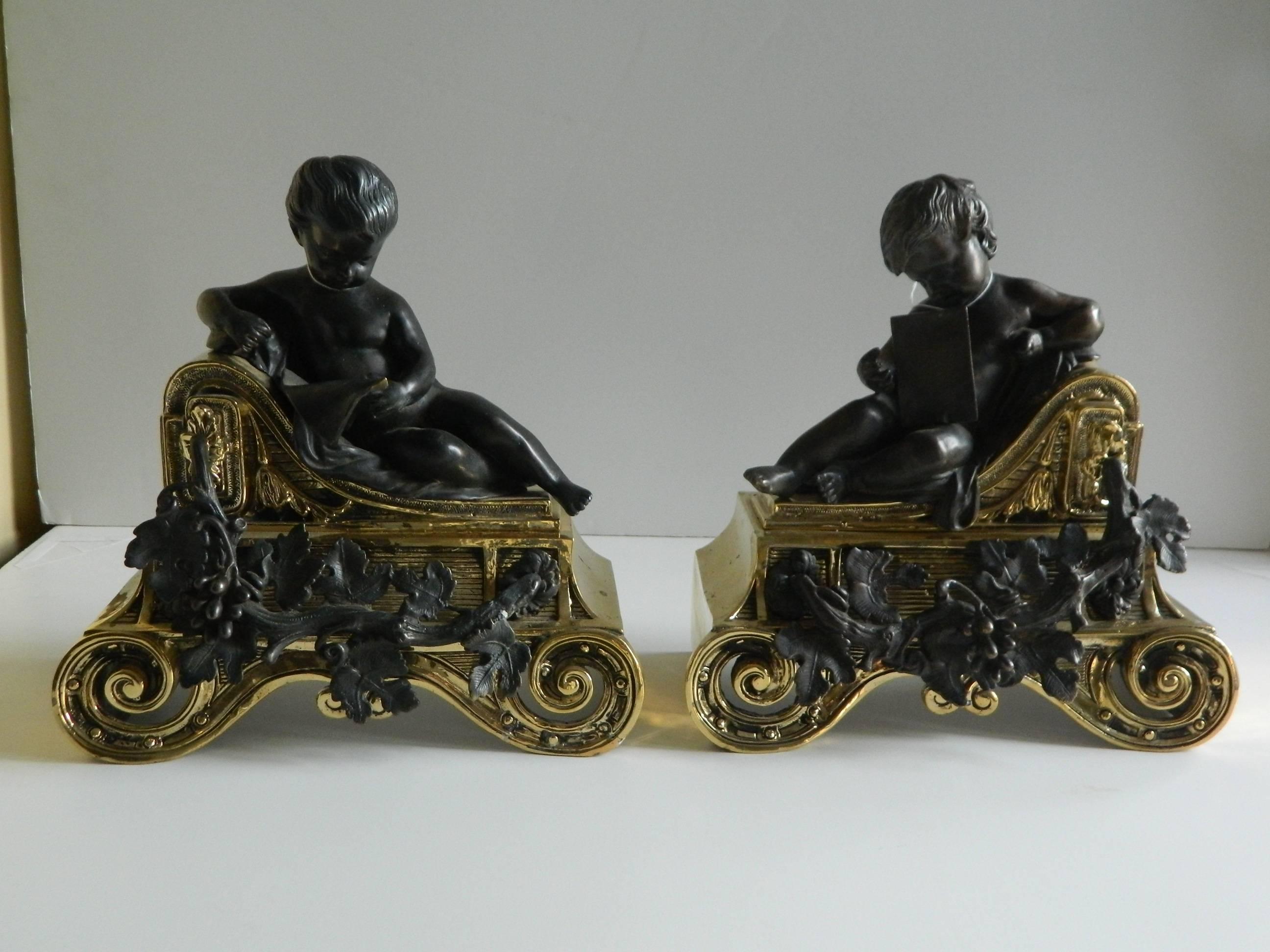 Pair of polished brass chenets or andirons with bronze cherubs, 19th century.
 