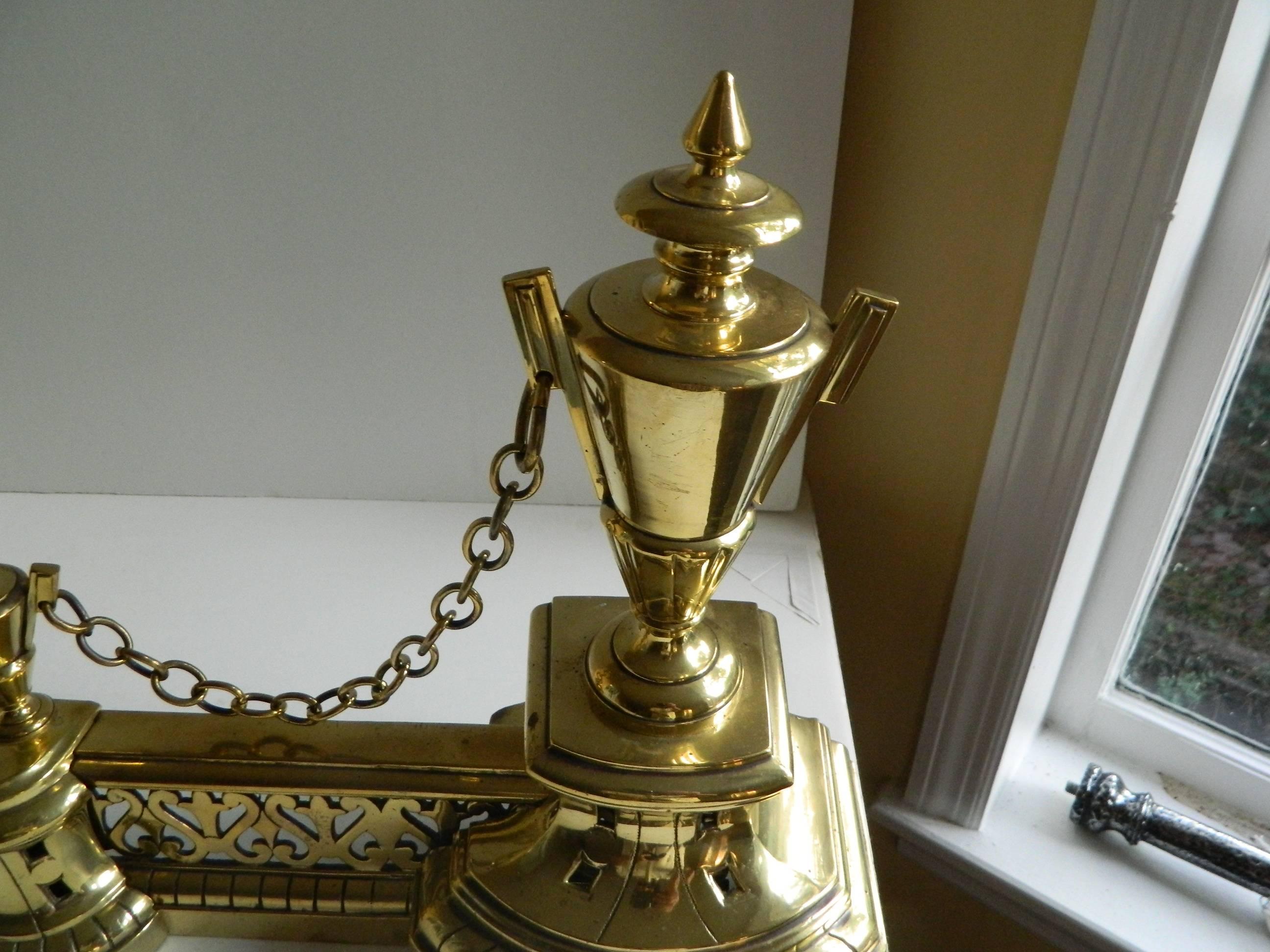 French Pair of Polished Brass Chenets or Andirons with a Fender, Large and Small Urns For Sale