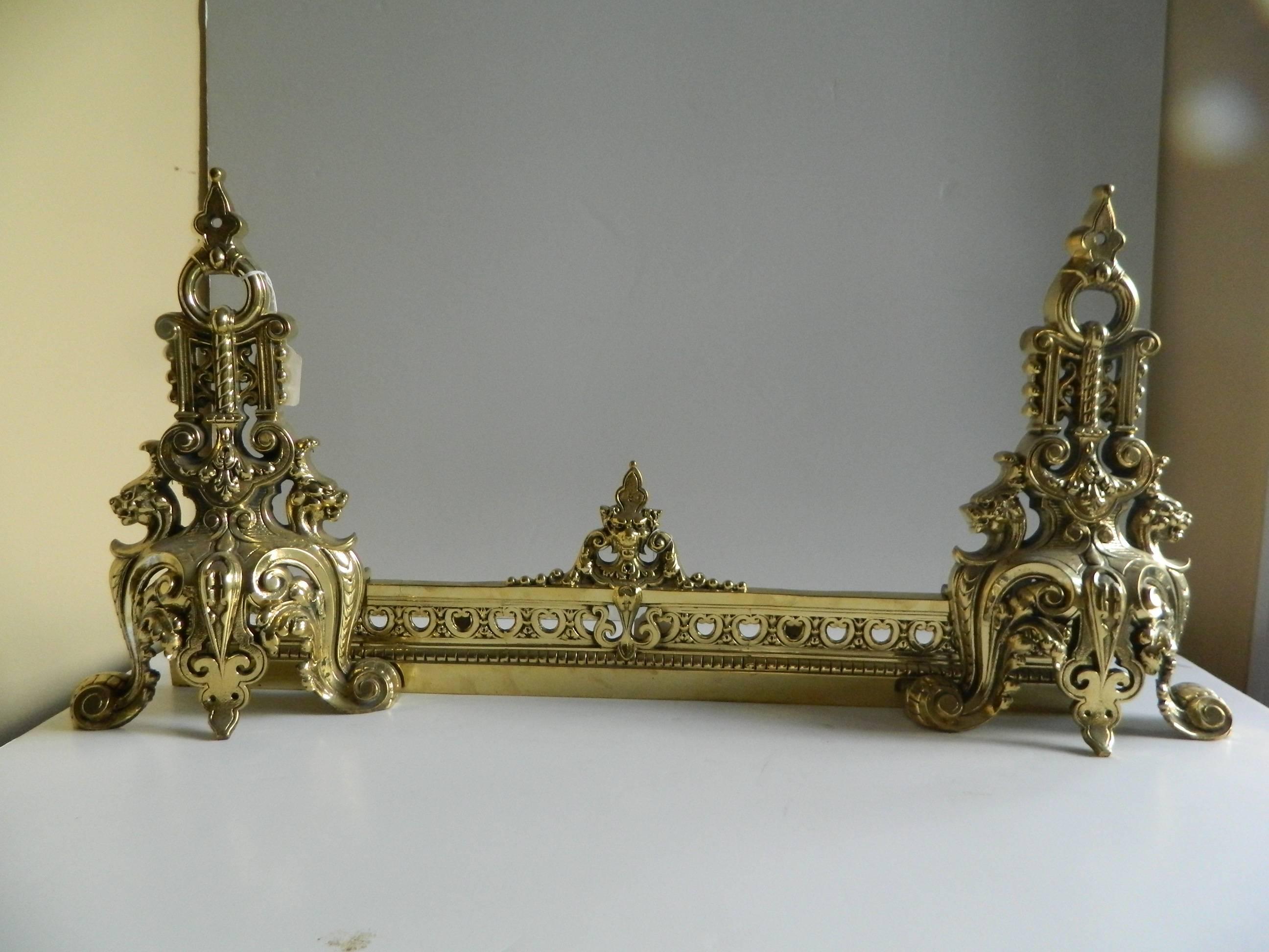 Pair of polished brass chenets or andirons with fender, dragons motif, 19th century.
   