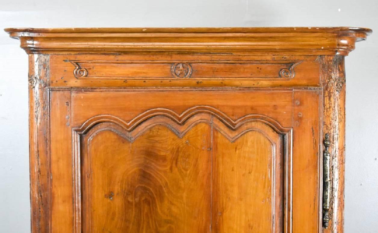 French Provincial Louis XV Fruitwood Bonnetiere, 18th century. Interior has been modified to hold a tv.