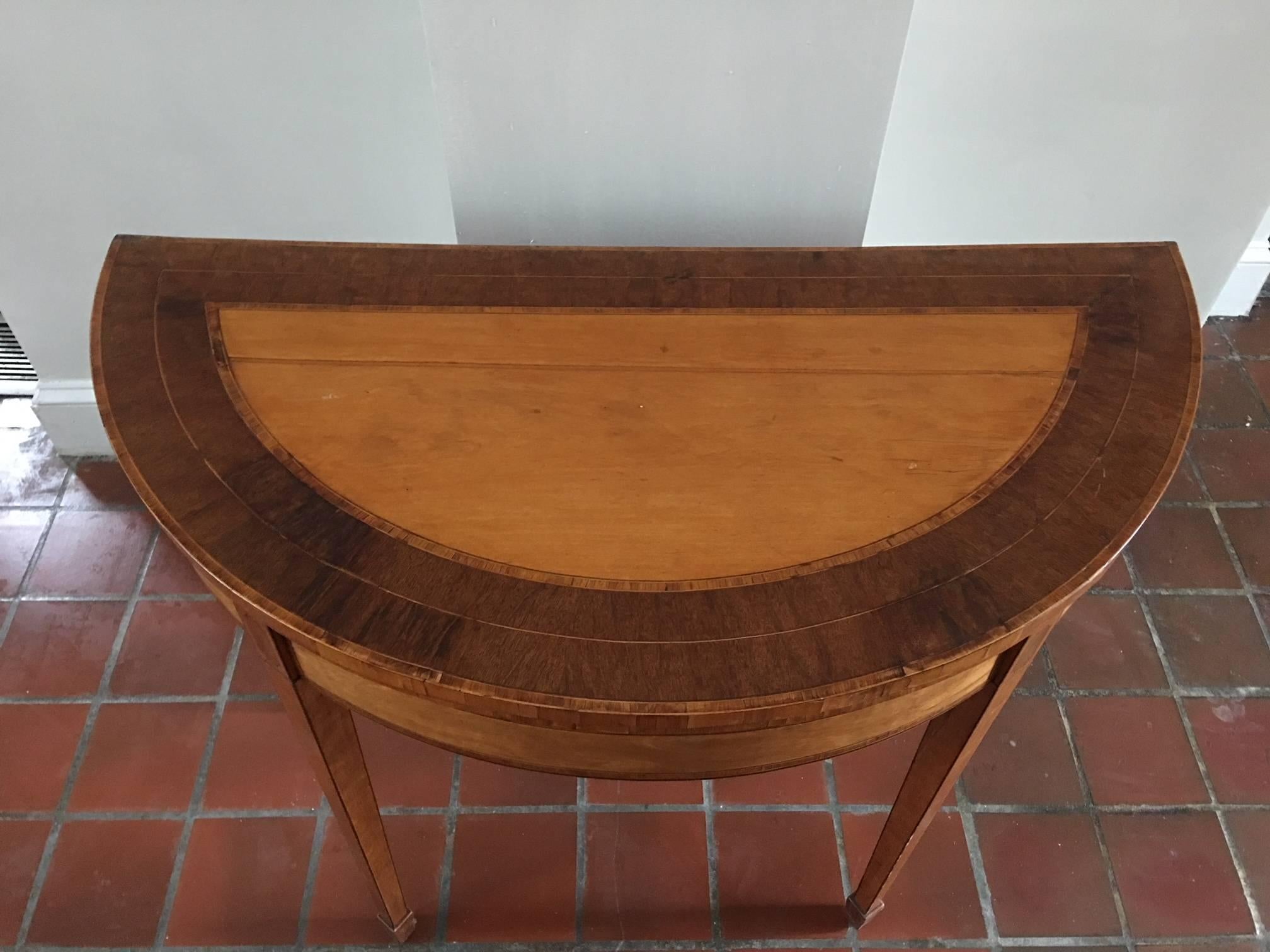 Irish Satinwood and mahogany games table with leather top, 19th century. Marlboro feet and window pane inlay.
  