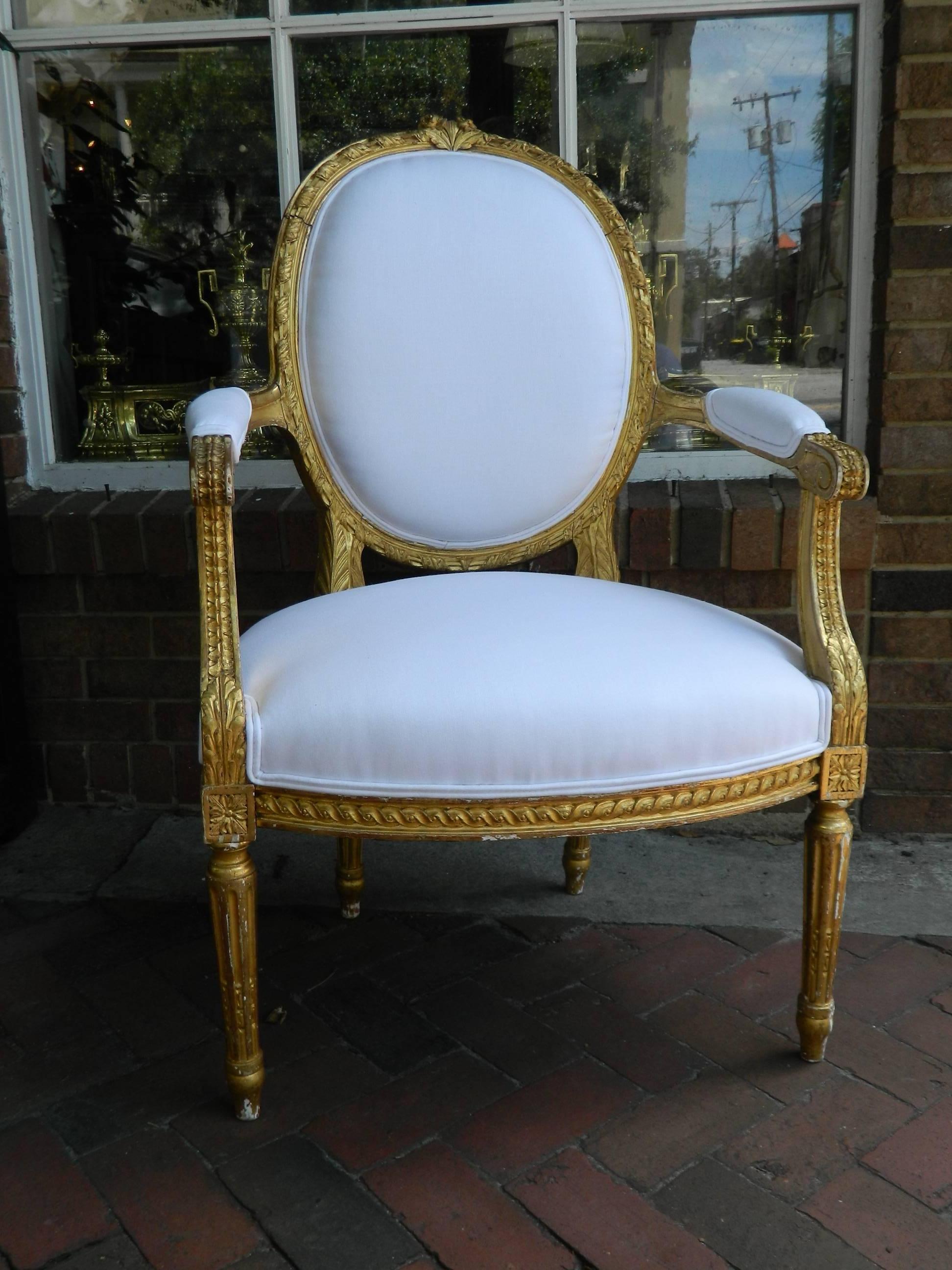 Pair of Louis XVI style giltwood armchairs, 19th century. Upholstered in off-white muslin.