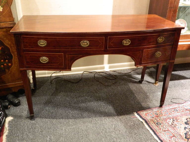 English mahogany and boxwood string bow front sideboard or desk, 19th century.