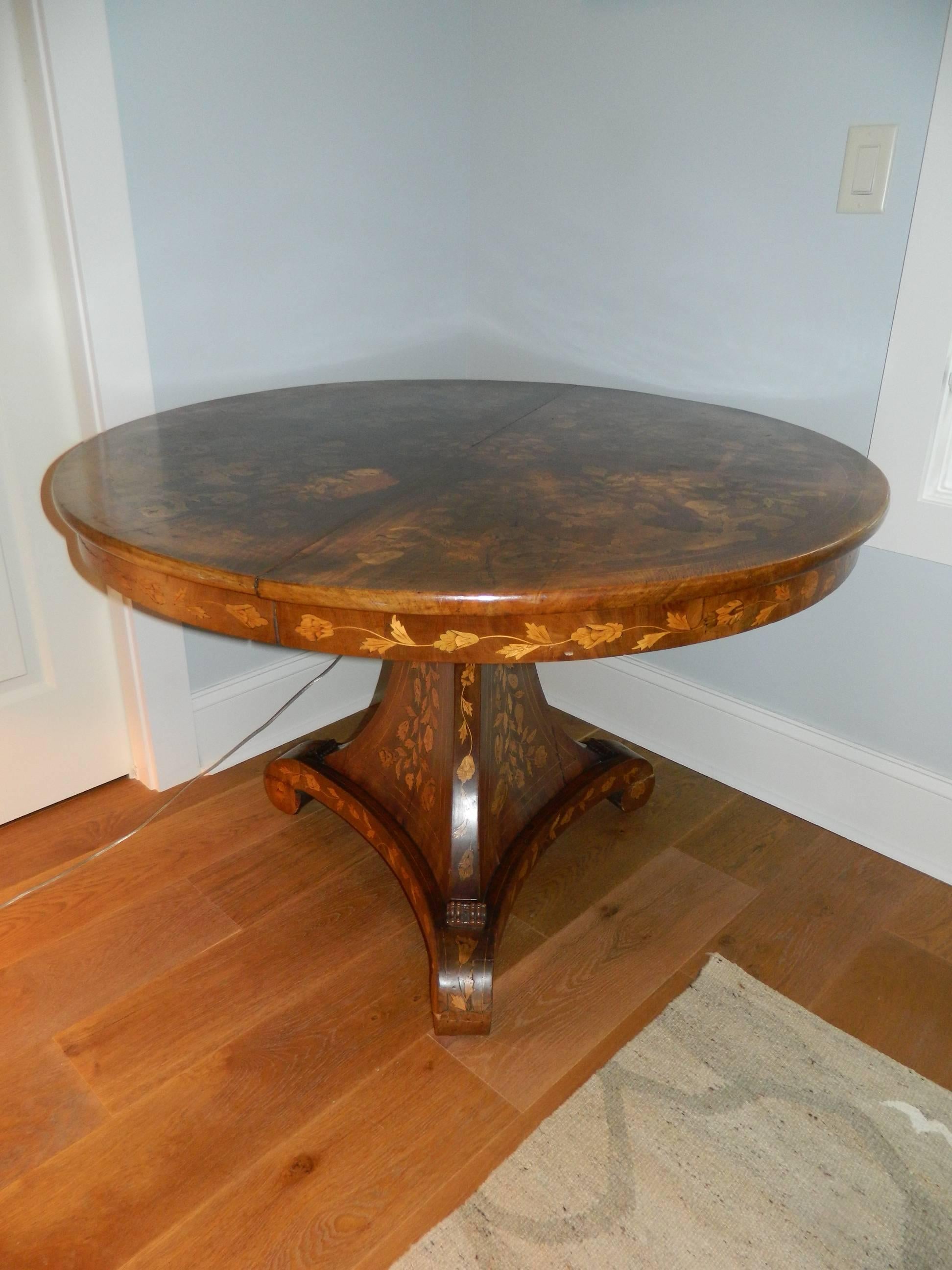Dutch round marquetry center or dining table on a pedestal, mid-19th century.   
  