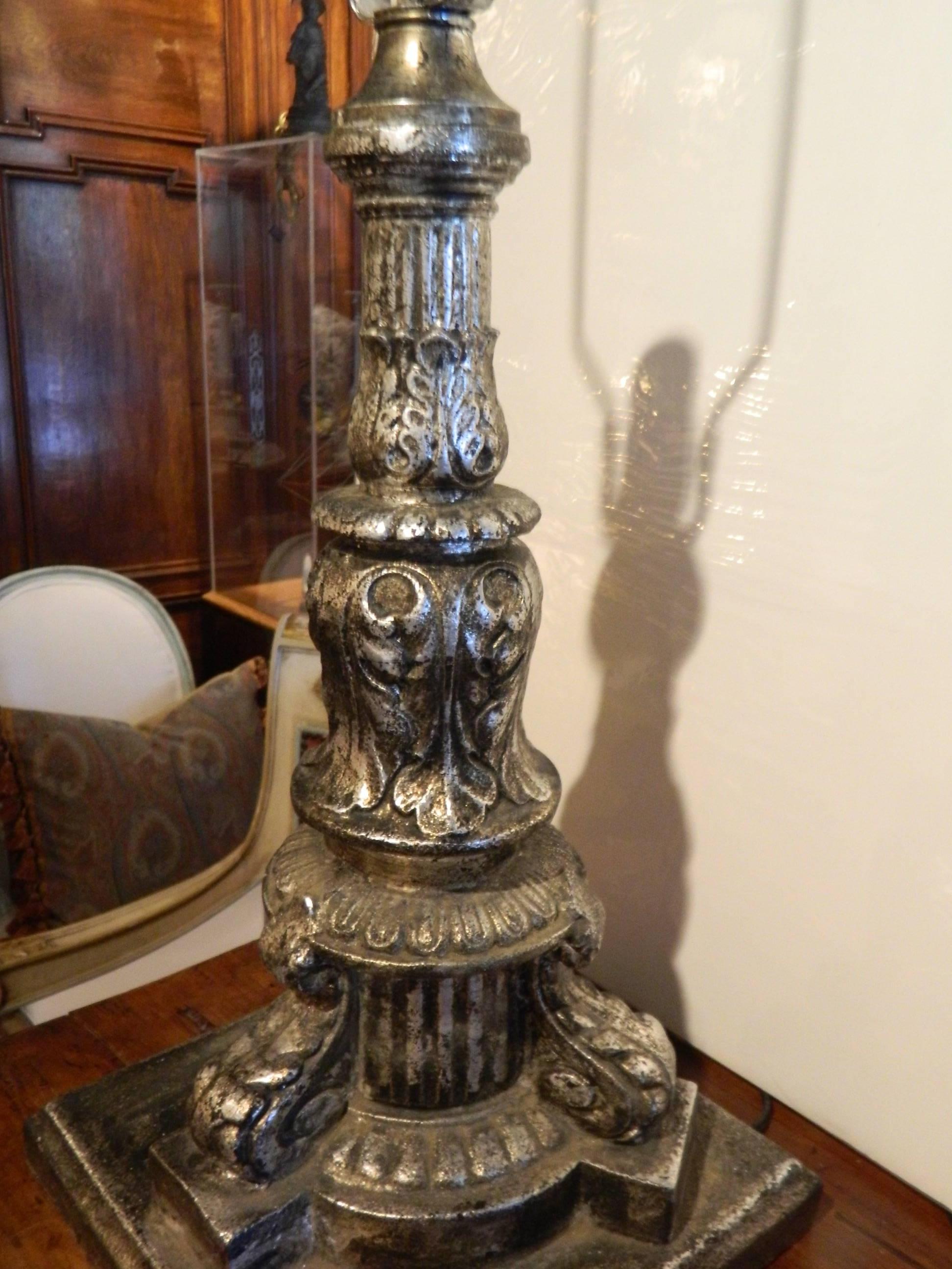 Pair of iron silver leaf architectural elements adapted as lamps, 19th century.
