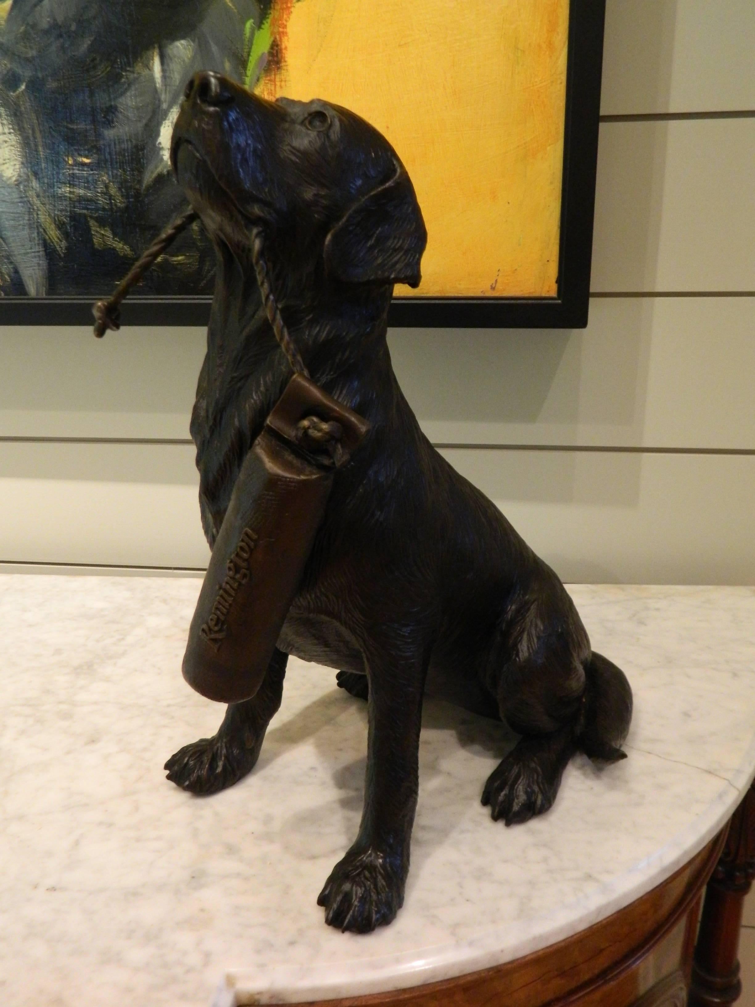 Bronze dog holding a buoy inscribed Remington, 20th century bronze dog holding a buoy inscribed Remington, 20th century.
 