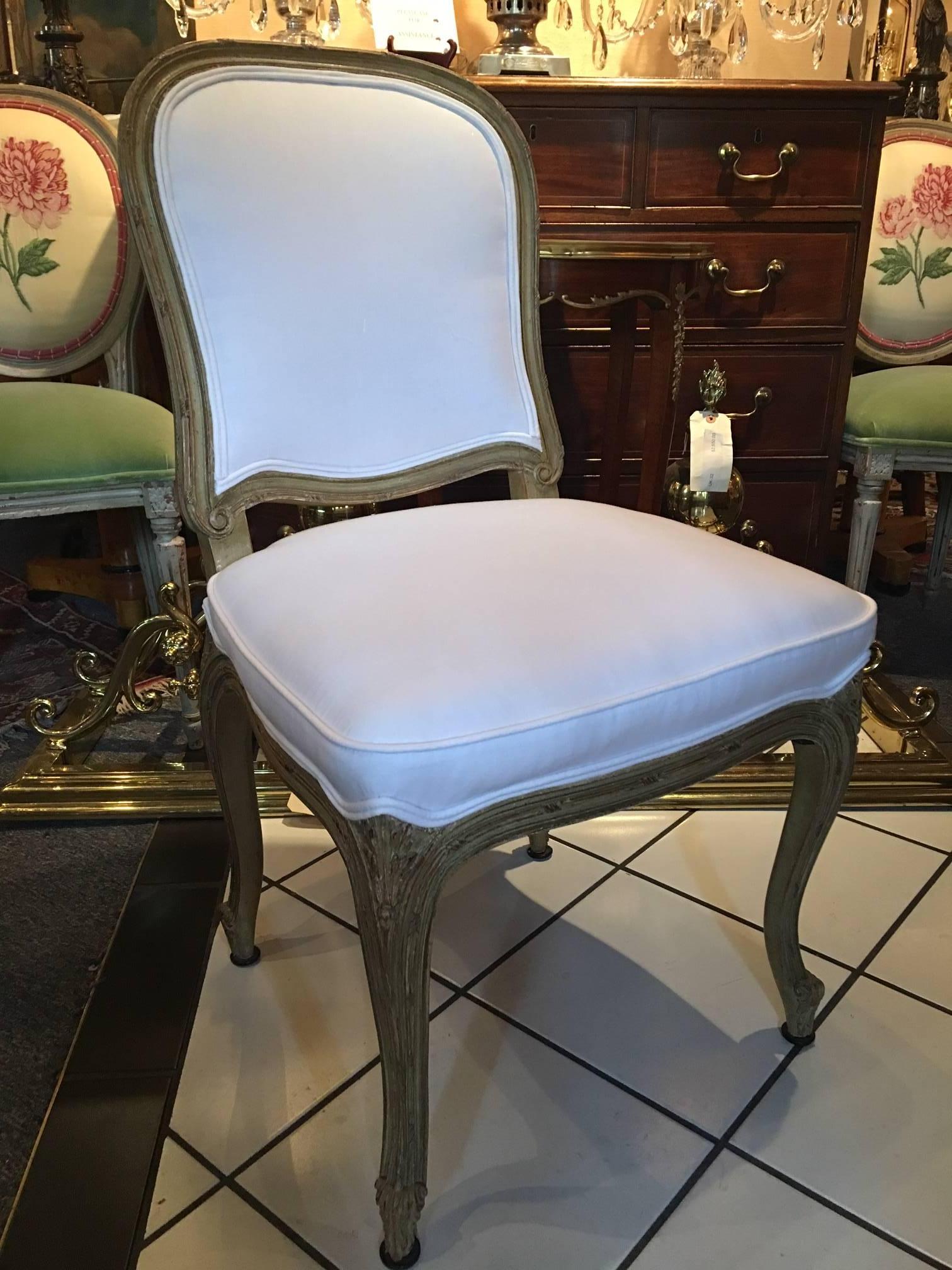 Set of four painted Louis XVI style dining chairs with cabriole legs, mid-20th century.
 