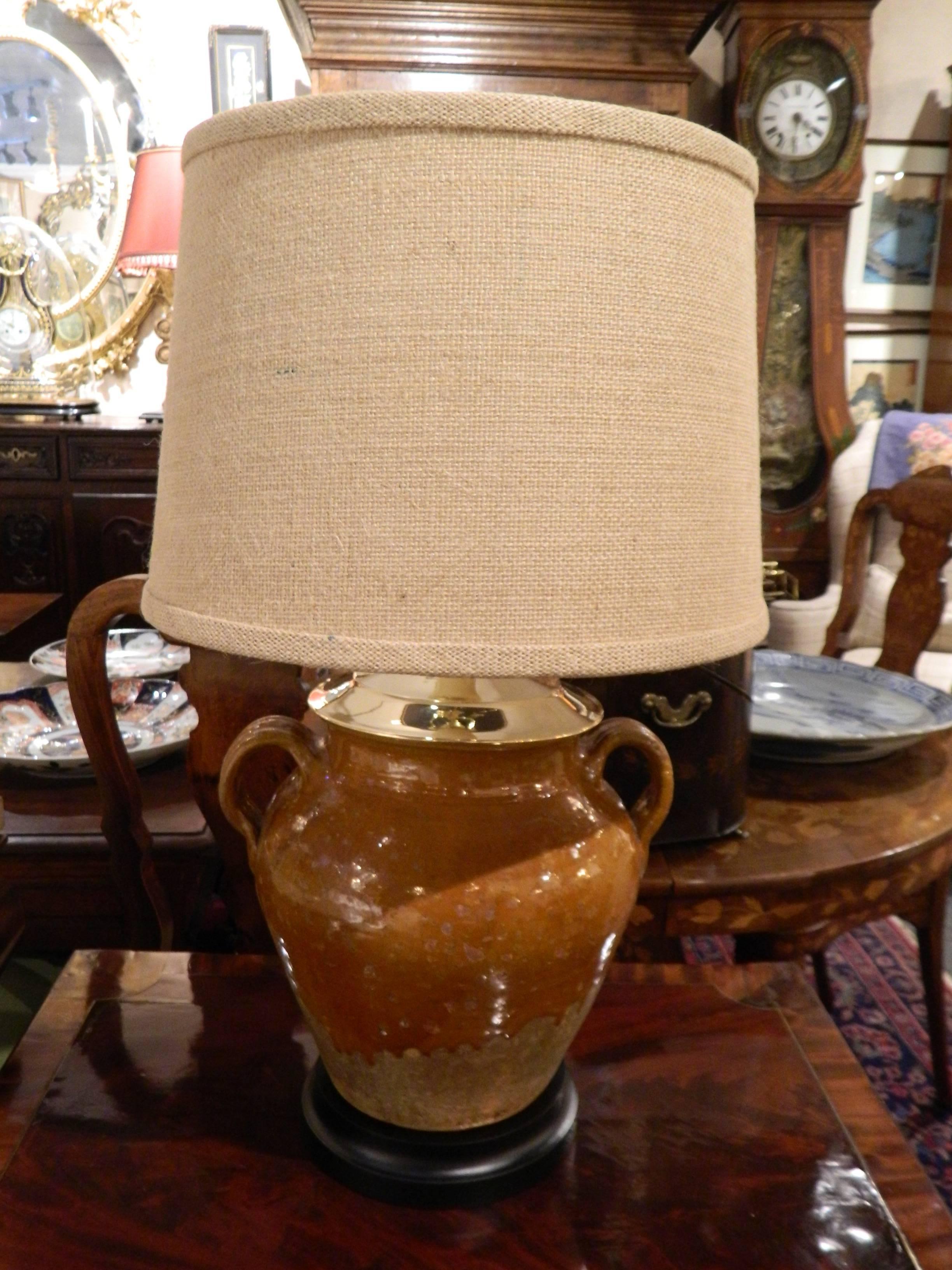 Provence two handle oil jar adapted as a lamp, early 20th century. Fitted with a burlap lampshade.