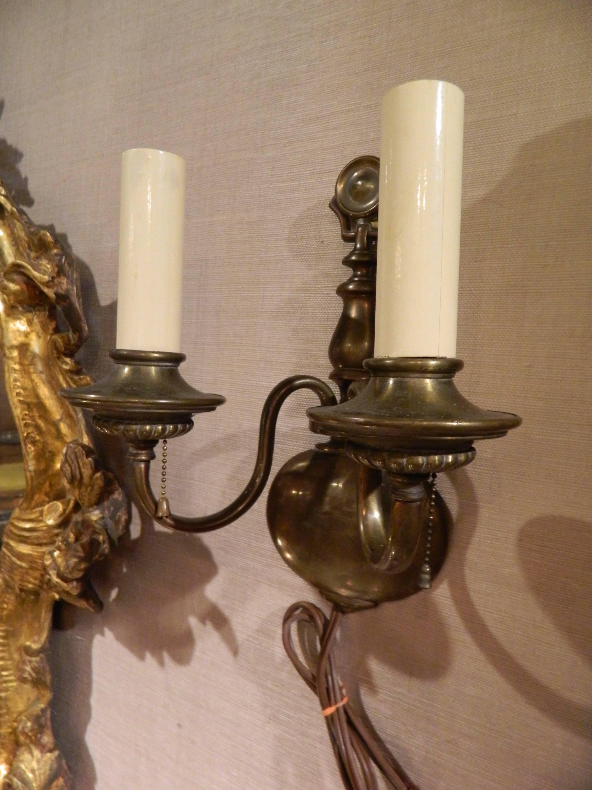 Pair of solid brass two-light wall sconces, early 20th century.
  