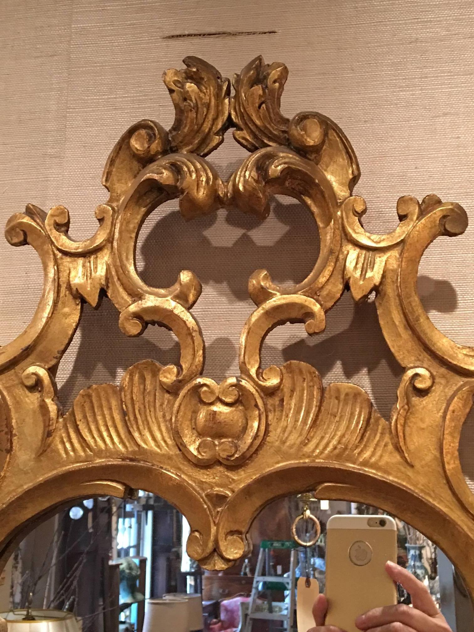 Pair of Italian Rococo style carved giltwood mirrors, early 20th century.
 