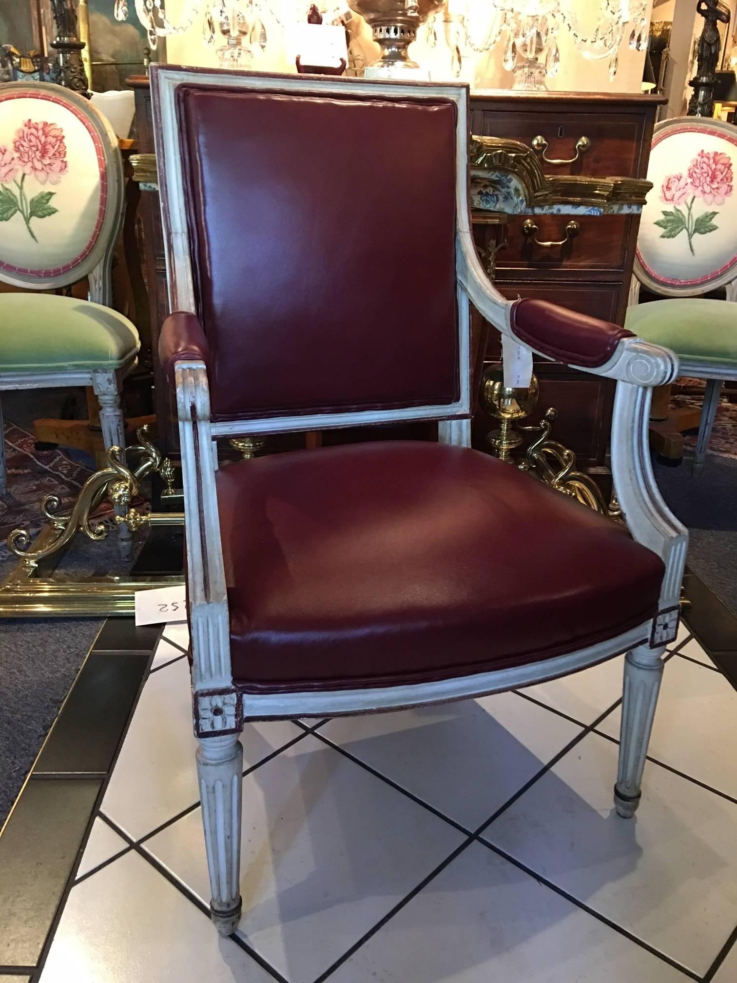 Pair of 19th century Louis XVI style painted fauteuils or armchairs upholstered in leather. Newly upholstered.