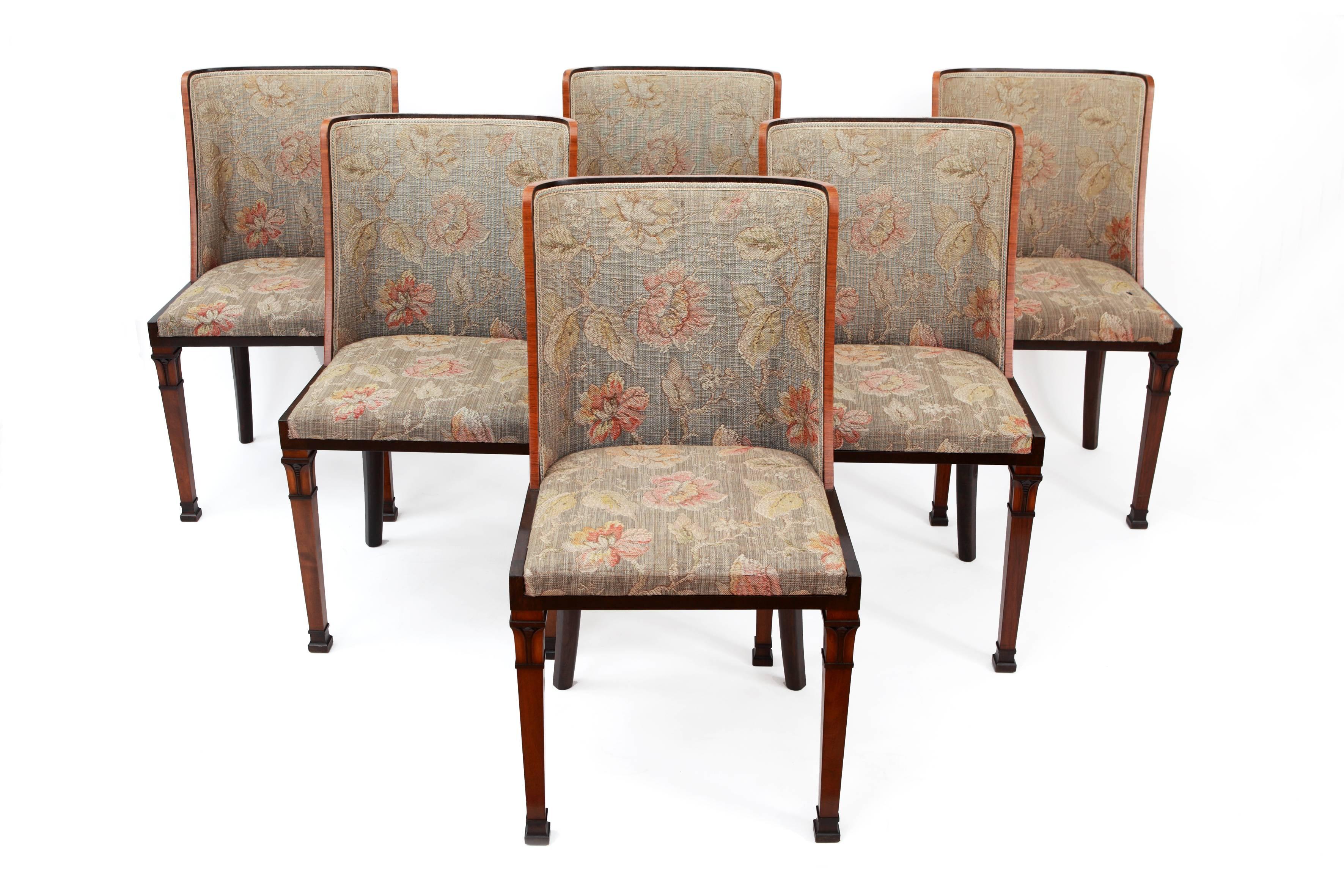 Various types of wood for the geometrical, classicized designs of the back rest and carved supports. Upholstery in fabric with floral design
Total H. 85 cm, H. seat 46 cm, W. 46 cm, D. 42 cm

These six dining chairs could be the work of Carl