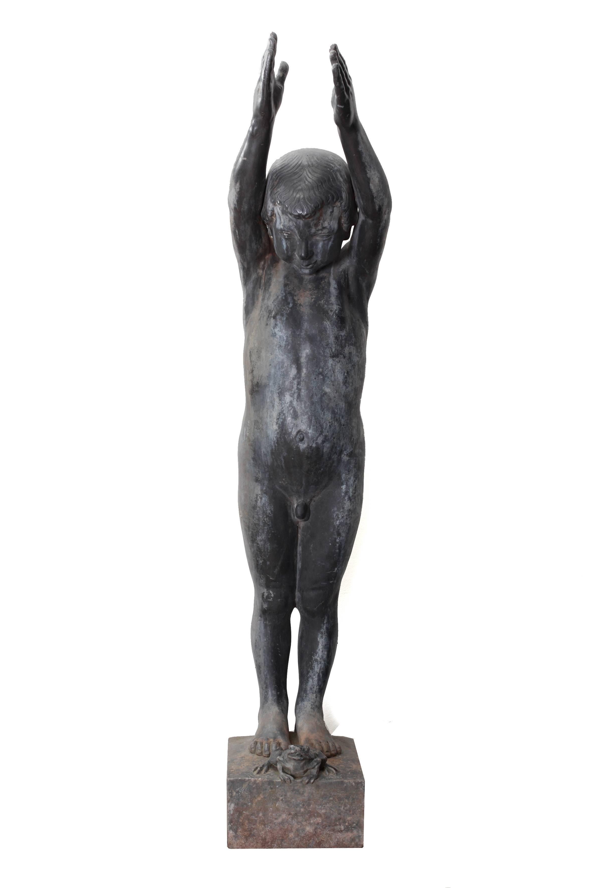A nude lead figure of a boy with both arms raised above his head seeming poised to dive into water, raised on a square plinth. Design by Walter Gilbert, modelled by Louis Weingartner. From the early 1900s Gilbert often worked in partnership with