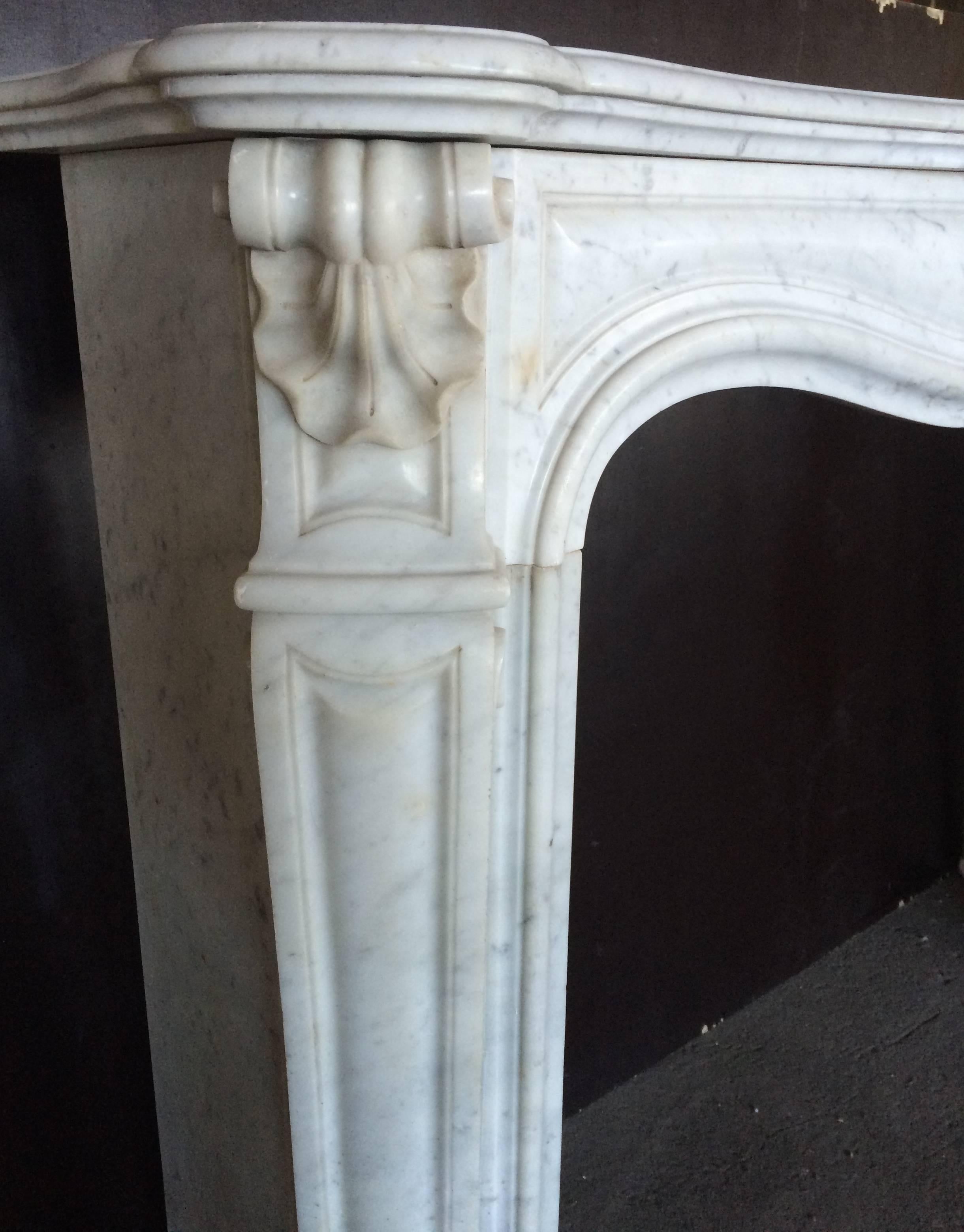 Excellent quality of art work from that period, beautiful detailed shell on the middle of the mantel, great leaves on top sides of the legs, great quality of marble.
Unique. Available right now for installation.
Interior firebox