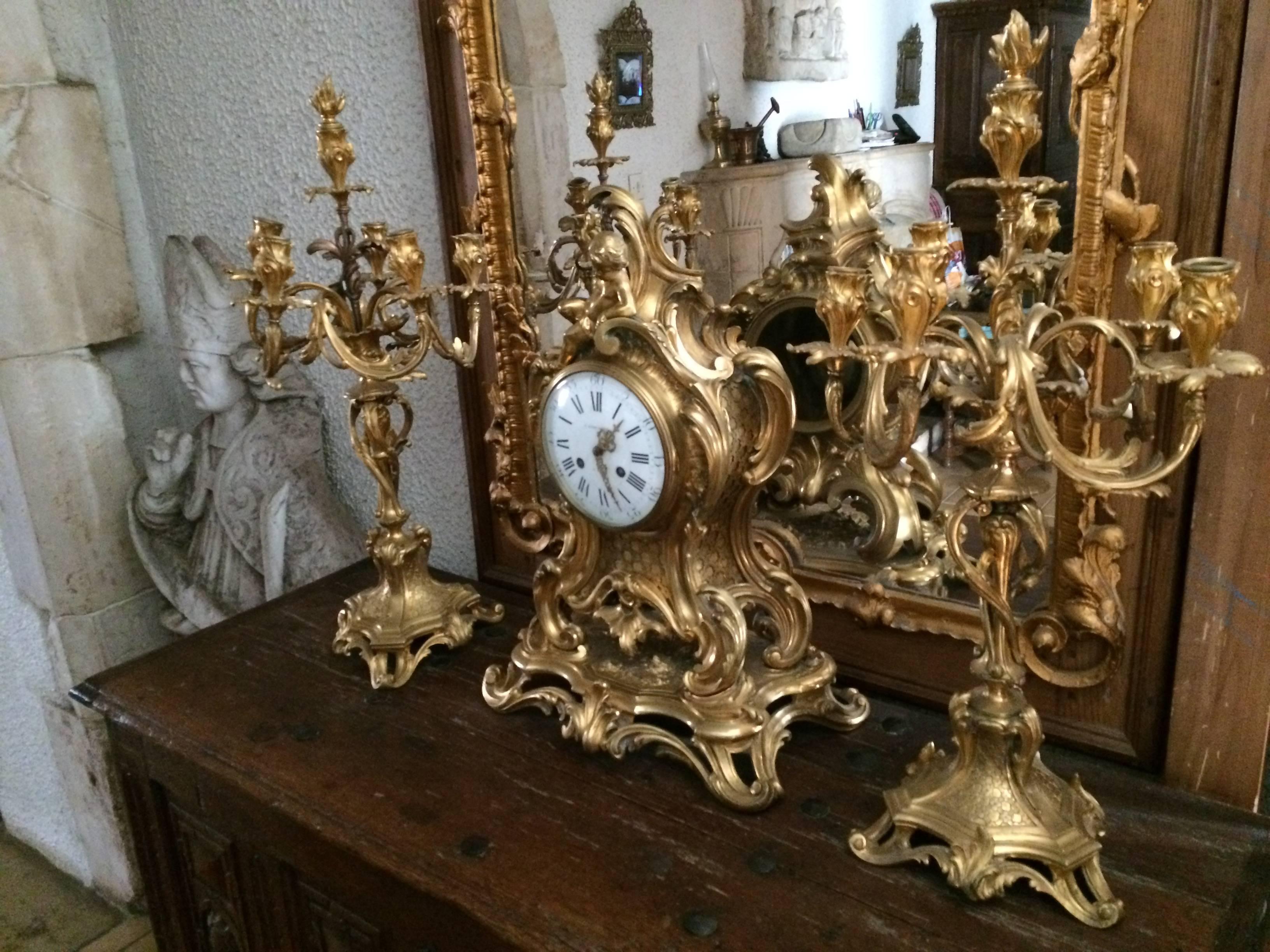 An exceptional, rare museum quality in solid gold-bronze clock and its original pair of candelabres, signed Barbedienne, 19th century, authentic, Paris.
French Parlement Louis XV style provenance.
In exquisite condition. Unique, rare and finally