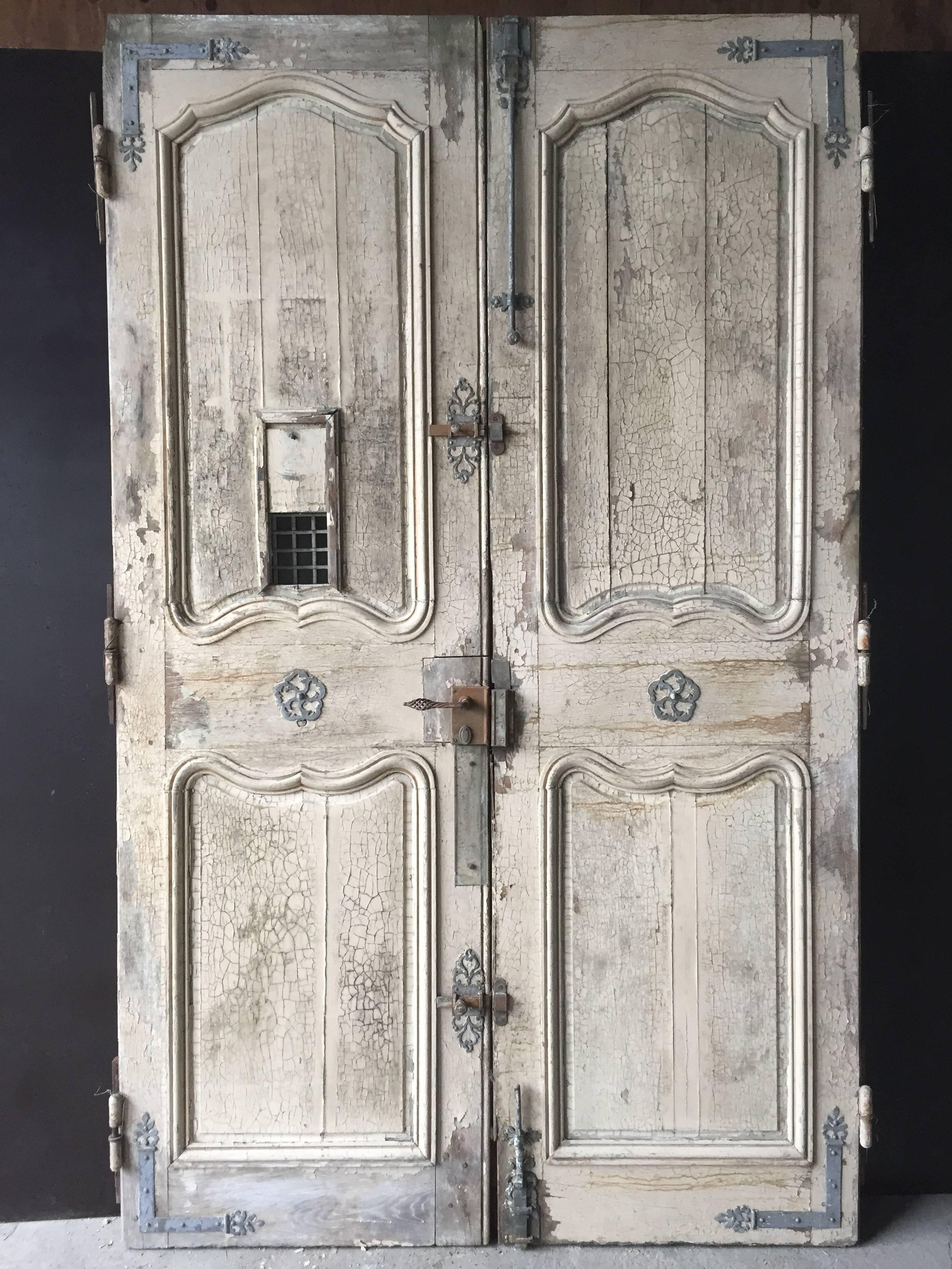 A rare set of original and authentic French chateaux front entrance doors (original pair), 18th century period, France.

Exquisite quality of handcrafted from 17th century.
Double faces, very thick and heavy.
Solid French antique wood oak from