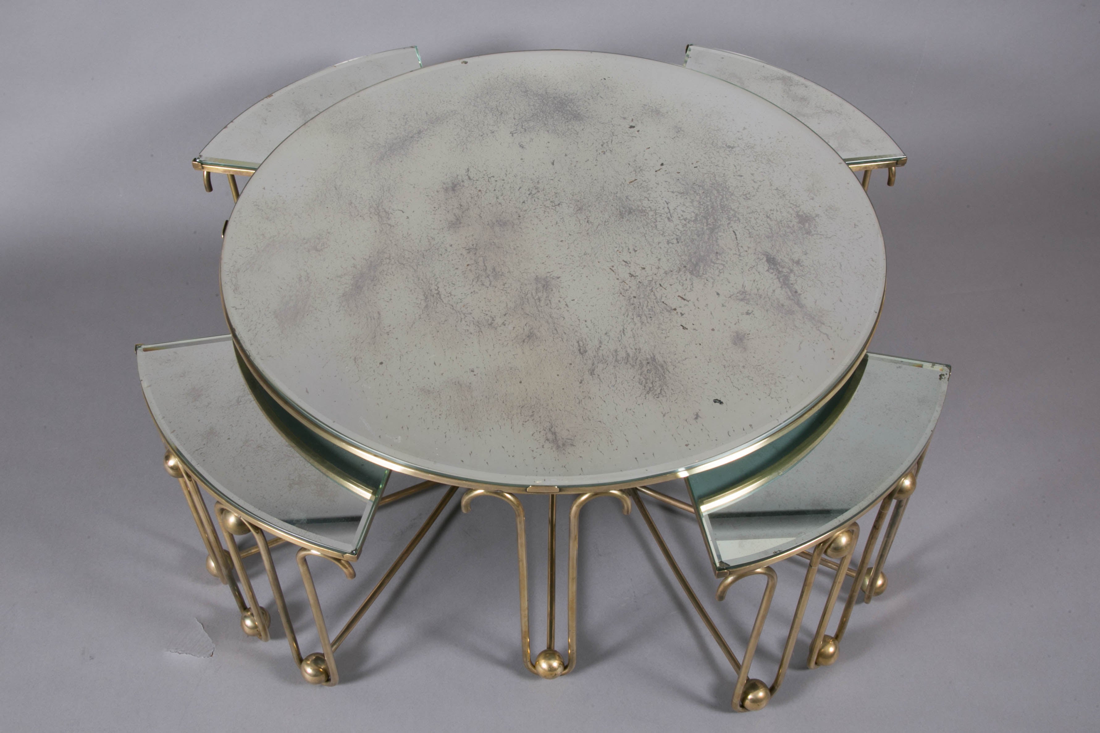 Beautiful gilt brass circular coffee table with four triangular nesting tables,
with bevelled mirror tops, by Jean Royère, 1950s.
Small tables: Height 35 x W 40 x D 36 cm.

R. Chavance, 