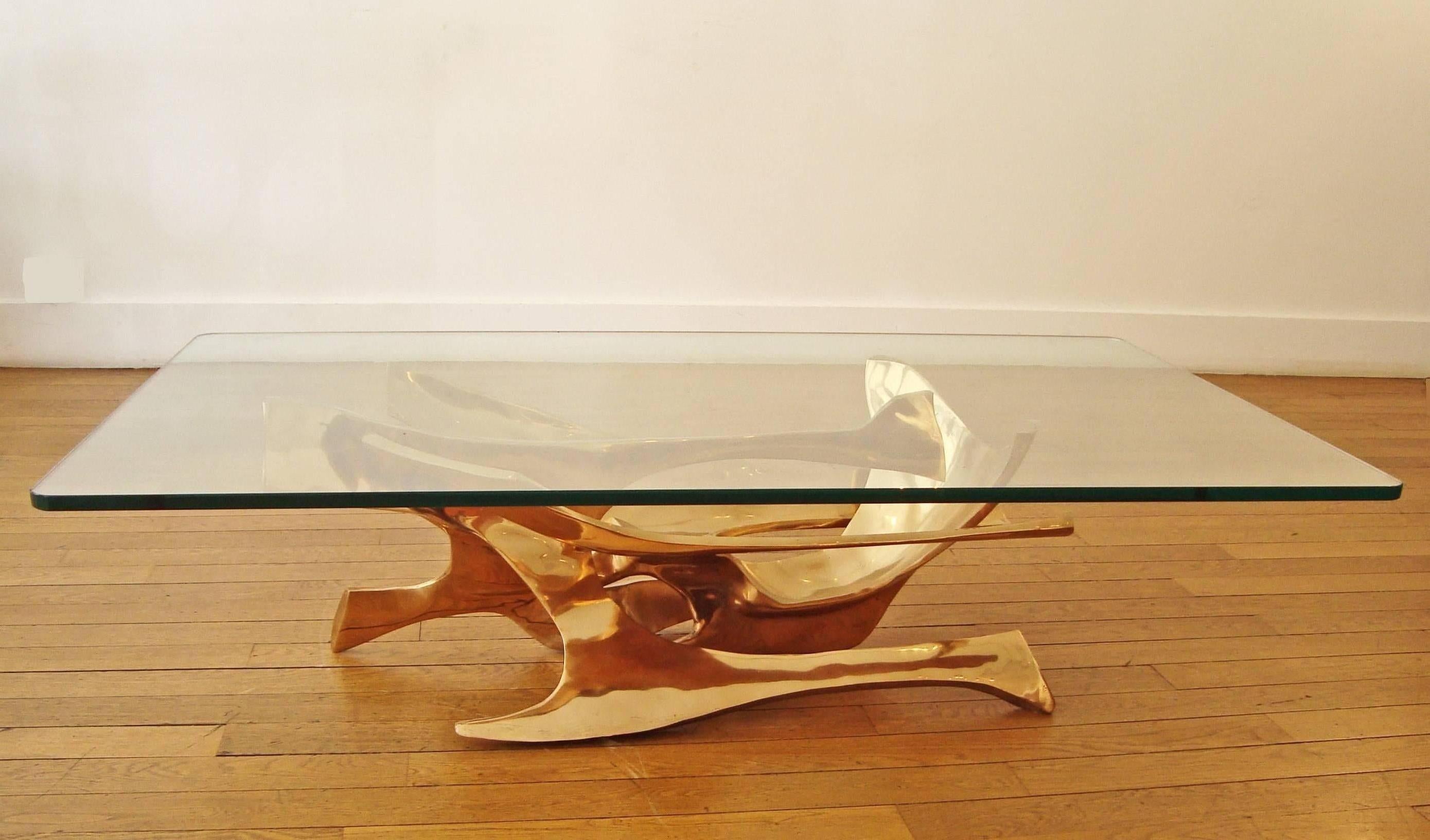 Beautiful gilt polished bronze sculpture as a coffee table by Fred Brouard, 1970s.
With a rectangular glass top.
Signed and numbered 2/4.
Bronze base only Height 13 x length 37 x depth 18 inches. 

Fred Brouard (1944-1999), met Alicia Penalba