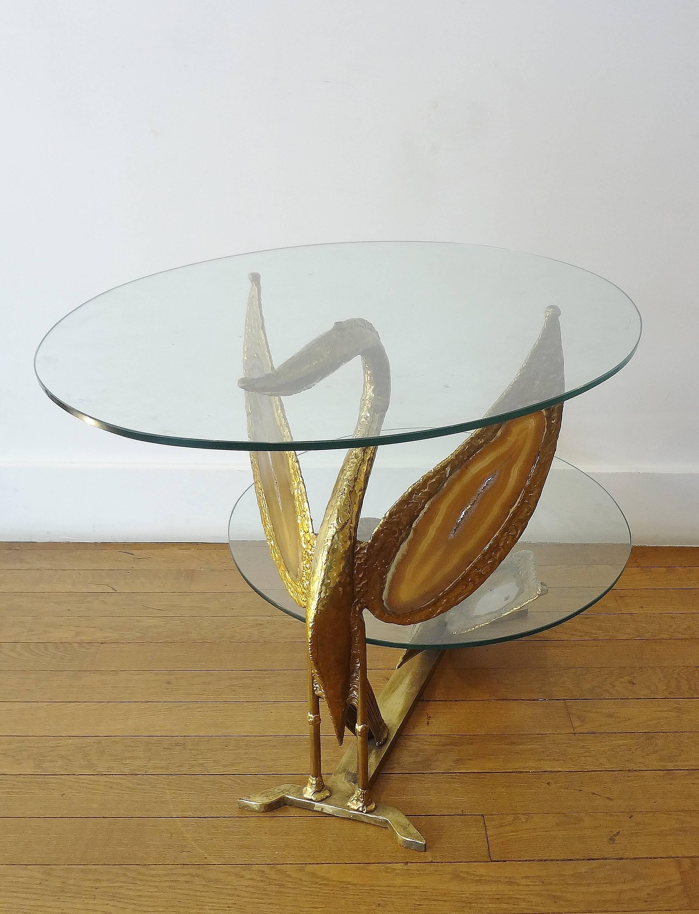 Henri Fernandez
Table basse en cygne-dragon, 1970s. 
Fantastic coffee table with two oval glass tops, 1970s
On a gilt brass and agate slices dragoon, swan sculpted base. 
Unique piece. Signed.  Under top at height 24 cm.

Henri Fernandez is a French