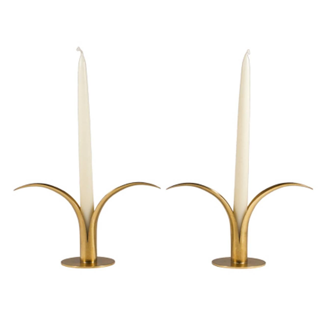 A pair of brass tulip candleholders by Ystad, Sweden. Sold as a pair. Six pairs are available.