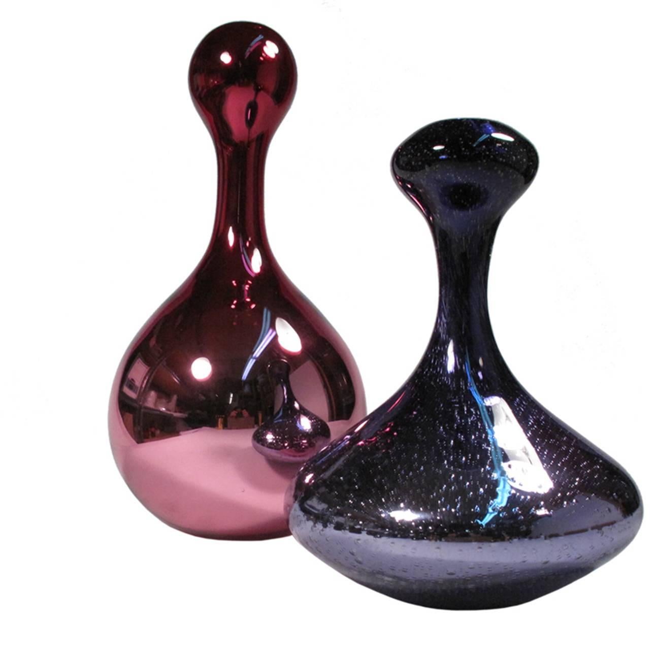 An amethyst colored metallic mouth-blown glass vase by a NYC artist. The vase is made using a double-walled process. The vase has a bubbled exterior and an opening at the top. Signed and dated by the artist.