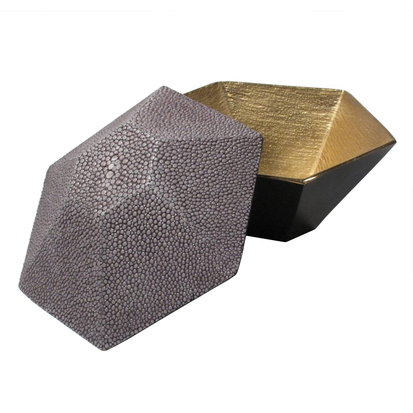 A geometrically shaped grey shagreen box with a blackened brass base. Brushed brass interior.
