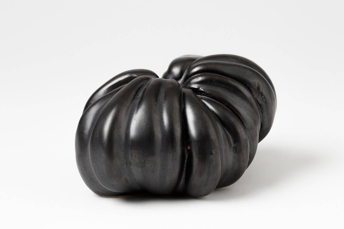 Sculptural porcelain by Tim Orr, circa 1970.

Elegant black ceramic glaze and perfect fruit form.

Signature under the base.

 