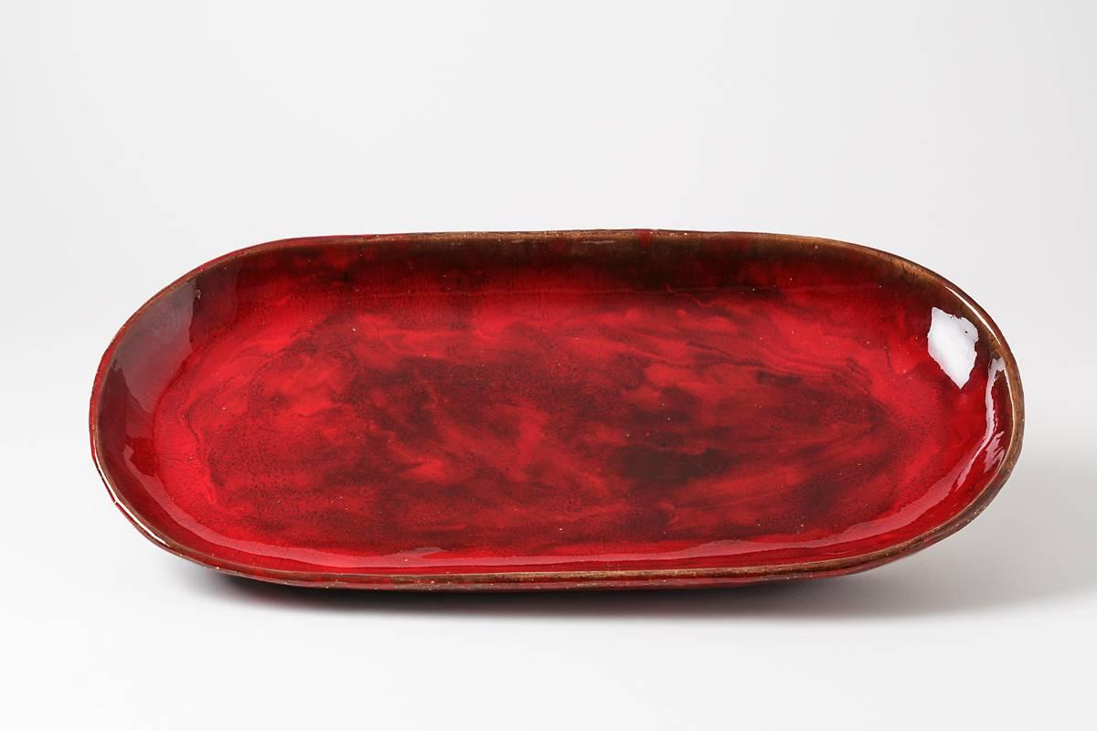 An important dish by Jean & Robert Cloutier with red glaze decoration.
Perfect original conditions.
Signed under the base 