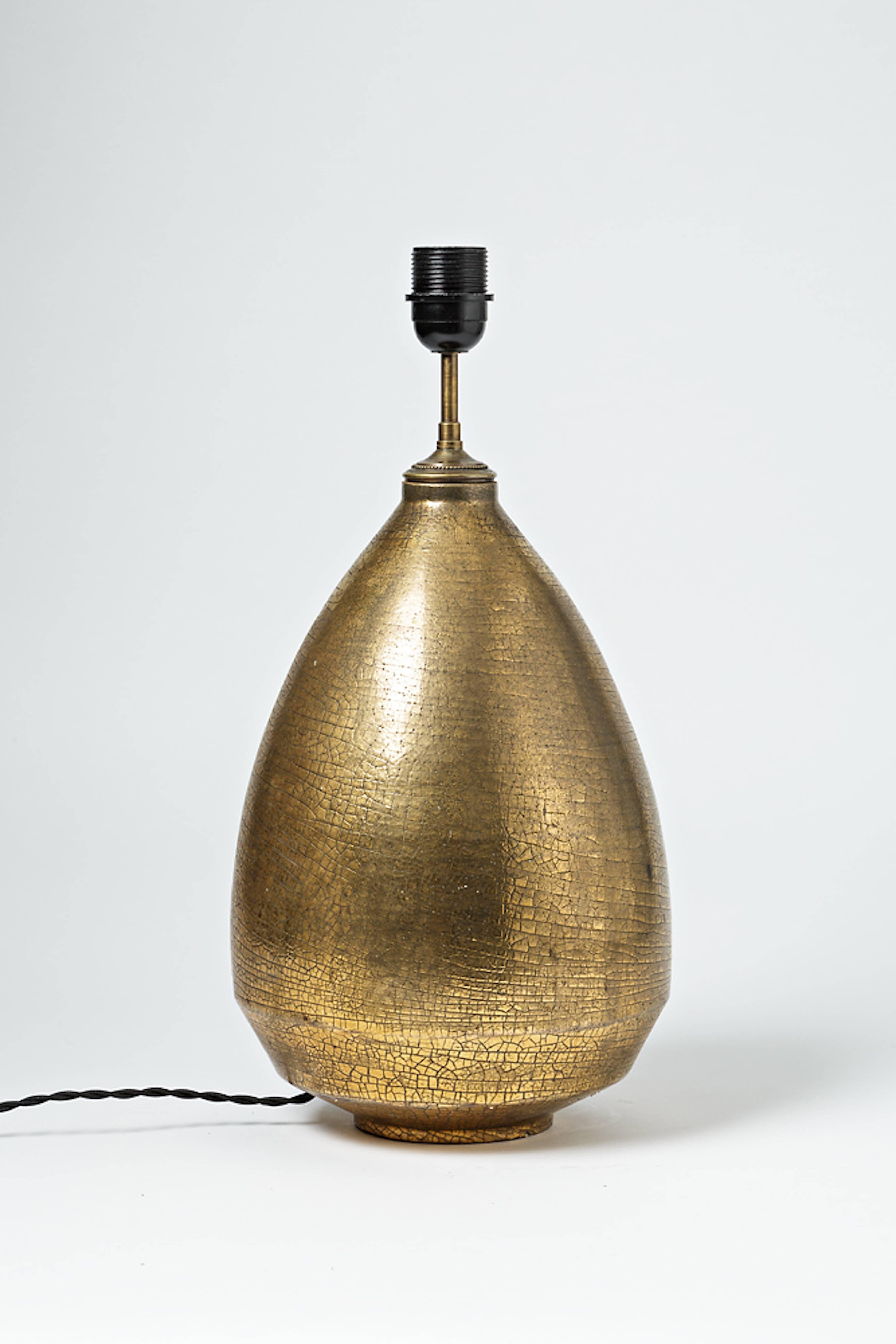 An important ceramic lamp with gold glaze by Marcel Guillard.
Perfect original conditions.
Unique piece.
Signature under the base,
circa 1930.

Sold without lampshade.
