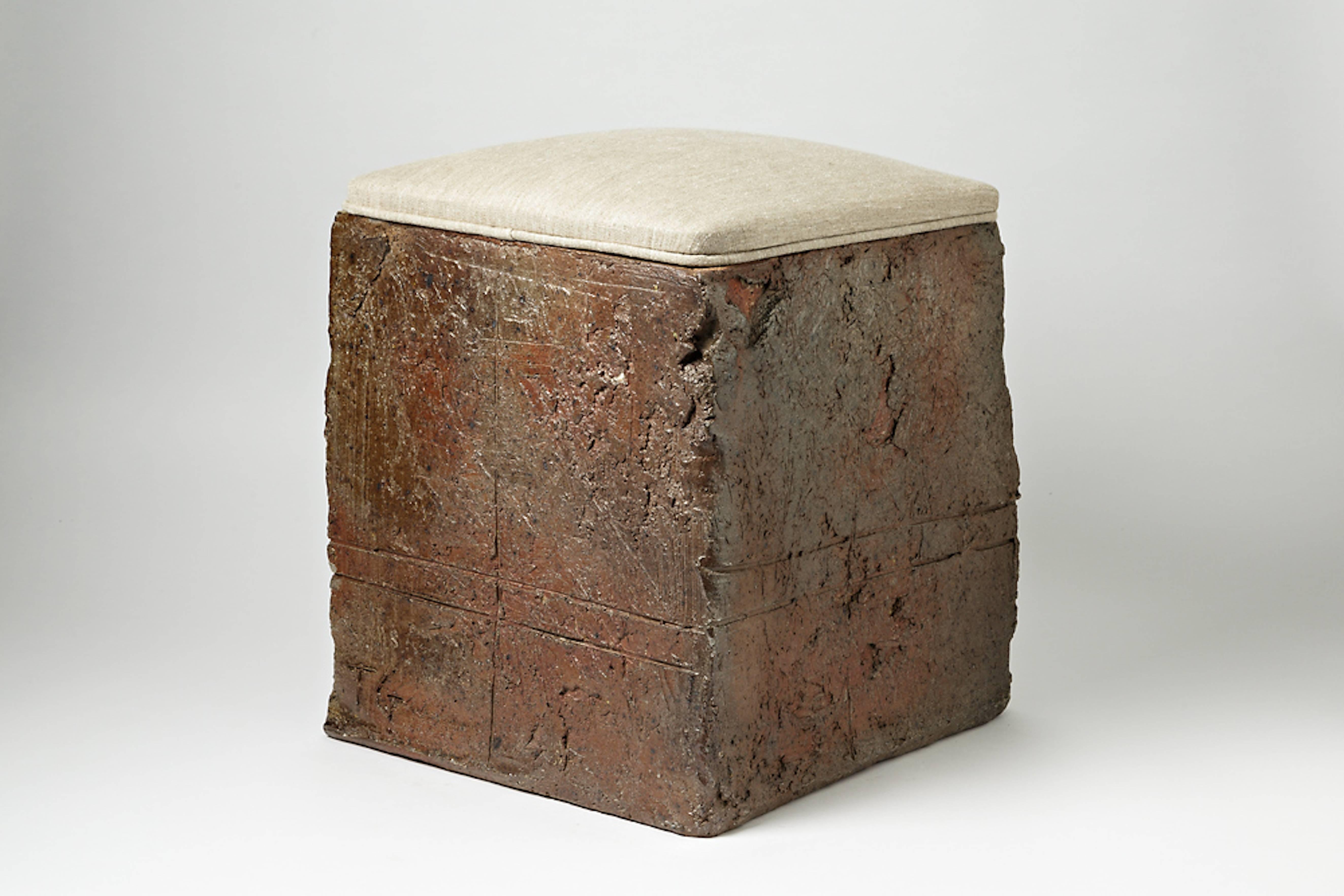 A stoneware stool by Gustave Tiffoche with grey fabric,
circa 1970-1975.